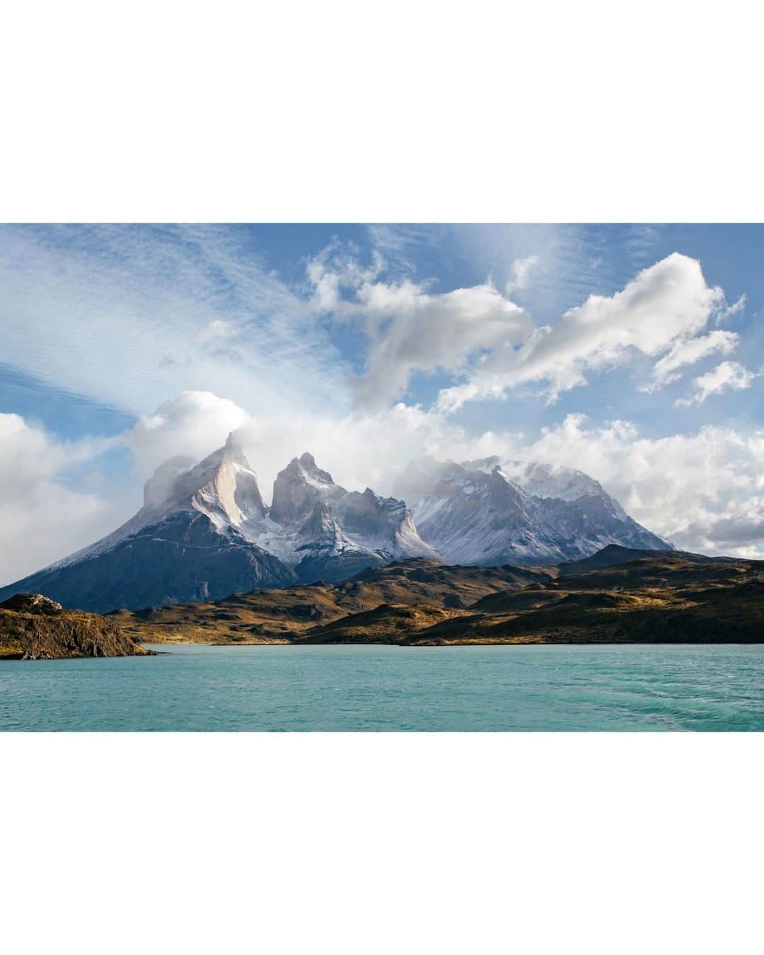 National Geographic Travelさんのインスタグラム写真 - (National Geographic TravelInstagram)「Photos by @michaelgeorge | Chilean Patagonia’s Torres del Paine is the rare park where humans are true outsiders in a vast, legitimate wilderness. Though it occupies 930 square miles (2,400 sq km), the park received only 140,000 visitors throughout 2022. Compare that with Zion National Park, where last year close to 4.7 million people explored its 232-square-mile (600-sq-km) expanse.  This image was captured as I traveled over Lago Pehoé, which translates to “hidden lake.” The brilliant color is caused by glacial flour, or rock dust suspended in the water. Prior to visiting Torres del Paine, I presumed all photos I’d seen of it had the saturation turned up to exaggerate the colors. I was pleasantly surprised that this is not so—those colors are precisely how they look. It’s as if all the natural features that make a landscape beautiful are turned up a notch. In the distance you can see Macizo Paine, a group of mountains that look like broken teeth.」12月15日 14時44分 - natgeotravel