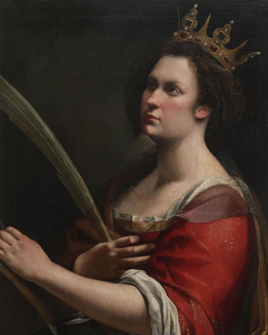 ニュー・ミュージアム・オブ・コンテンポラリー・アートのインスタグラム：「Italian Baroque painter Artemisia Gentileschi rose to prominence during a period when artistic production was overwhelmingly dominated by male artists supported by their studios. Gentileschi’s selection of strong, heroic, female protagonists allowed her to explore women’s experiences and inner lives in a way that was highly uncommon at the time.  Painted over 400 years ago, Gentileschi’s portrait of Saint Catherine of Alexandria (ca. 1620) begins to tell @judy.chicago’s “Herstory” of art in “The City of Ladies” installation on the Fourth Floor. Using herself as a model, Gentileschi depicts the brilliant fourth-century theologian who was martyred for refusing to renounce her Christian faith and marry the Roman Emperor Maxentius.   The portrait takes on additional weight given that at the age of 17, Gentileschi was raped by her mentor Agostino Tassi, which led to a highly publicized trial. Though found guilty, Tassi was released by the judge, who ordered Gentileschi to be tortured as a means of proving her honesty. This portrait might therefore be read as an expression of Gentileschi’s own persecution and an assertion of defiant autonomy.  Artemisia Gentileschi, “Saint Catherine of Alexandria,” ca. 1620. Gallerie degli Uffizi @uffizigalleries   #ArtemisiaGentileschi #JudyChicagoHerstory」