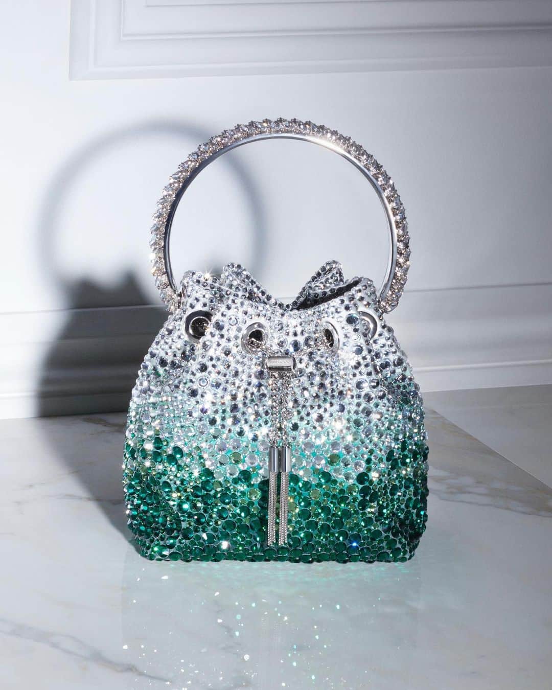 Jimmy Chooのインスタグラム：「Enlived with dégradé crystals and an exquisite bracelet handle, the iconic Bon Bon is the ultimate sartorial statement #JimmyChoo」