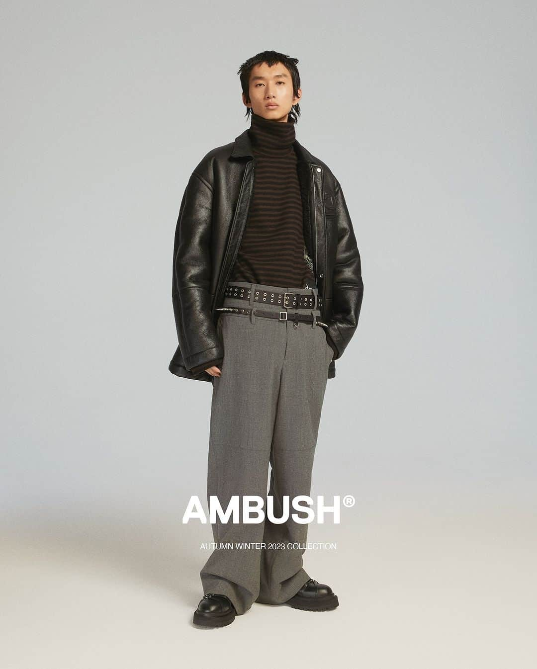 AMBUSHのインスタグラム：「#AMBUSH AW23 COLLECTION LOOK 14  LONG SHEARLING COAT STRIPES BOILED WOOL T.NECK DOUBLE BELTED TROUSERS FW23 CLASS RING AMBLEM GROMMET BELT SPIKE STUDS BELT SMALL BARBELL RING MISFIT RING SID LOAFER  Now available at our WEBSHOP and WORKSHOP.」