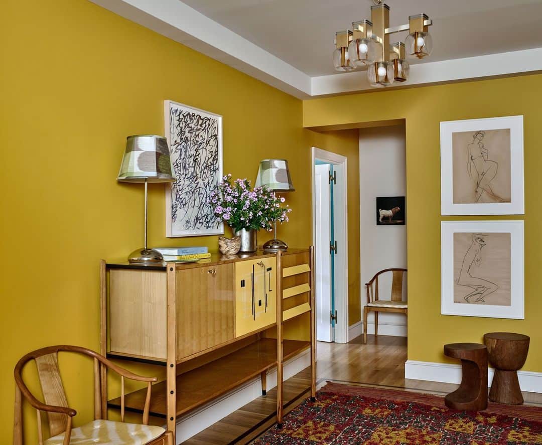 ELLE DECORのインスタグラム：「It’s a sunshine state of mind every time you open the door to this rich yellow entryway in the home of Dexter star Michael C. Hall (@mchdaily). Upon discovering designer Sara Bengur’s (@sarabengur) portfolio with his wife, Morgan, Hall knew she was just the person to transform their Manhattan apartment. “We wanted something simultaneously sophisticated and playful—and we wanted color!” says Hall. “Sara’s spaces have an ease and flow that immediately appealed.” In addition to color, the couple are avid art collectors, and their artworks were a key factor in the design of each space. Here, two drawings by Ai Weiwei are displayed in the hallway.   Click the link in bio for the full tour, as shown exclusively on elledecor.com. Written by @ingridabram. Photographed by @richardpowersphoto. Styled by @anitasarsidi.」