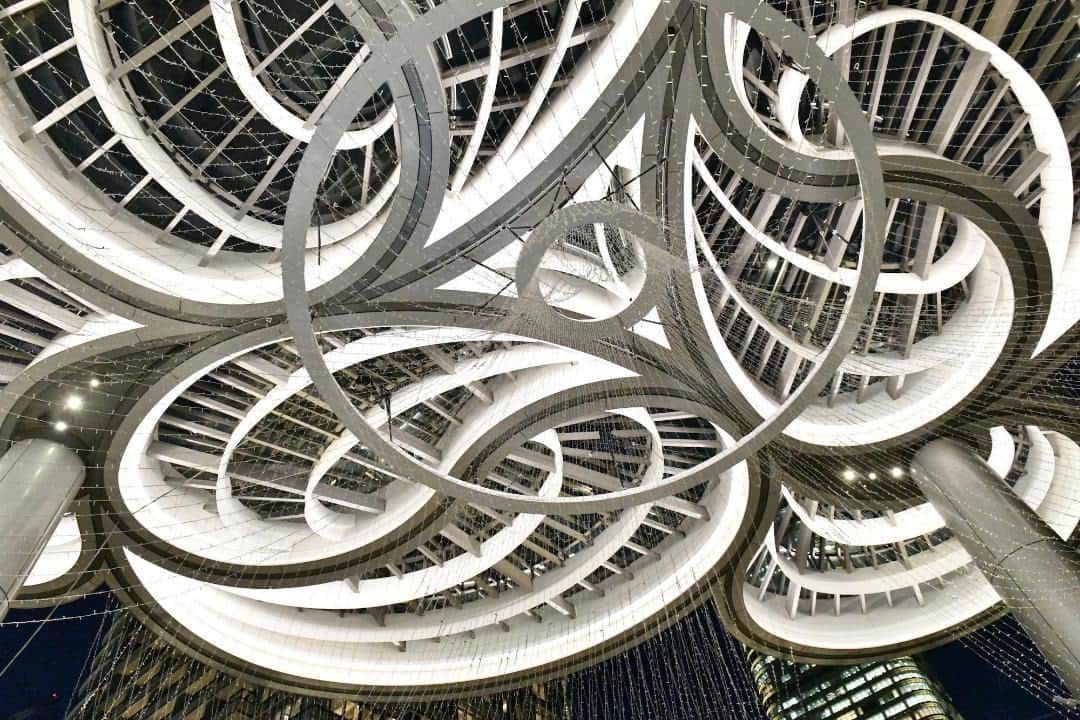 The Japan Timesさんのインスタグラム写真 - (The Japan TimesInstagram)「Mori Building’s new mixed-use complex in Tokyo, Azabudai Hills, is aiming to redefine city living by integrating extensive green spaces within a high-density urban area.  This reimagined “city within a city,” which opened in the capital's Minato Ward on Friday, will host approximately 20,000 office workers and 3,500 residents when fully occupied and is expected to welcome 30 million visitors per year.  Within this sprawling development is the main Mori JP Tower, which at 330 meters is now the tallest building in Japan and houses both residences and office spaces; the Keio University Center for Preventive Medicine; the primary school campus of the British School in Tokyo; the relocated teamLab Borderless Digital Museum; and two tall residence towers.  The project boasts about 24,000 sq. meters of green space, with the central area spanning approximately 6,000 sq. meters. The structures and landscape design, developed by U.K. firm Heatherwick Studio, showcase a range of plant species, with more than 320 different types planned for the area. Read more with the link in our bio.  📸: @louise.claire.wagner  #azabudaihills #tokyo #japan #moribuilding #architecture #design #HeatherwickStudio #teamlab #tokyoarchitecture #麻布台ヒルズ #東京 #建築 #森ビル #チームラボ #東京建築」11月26日 19時40分 - thejapantimes