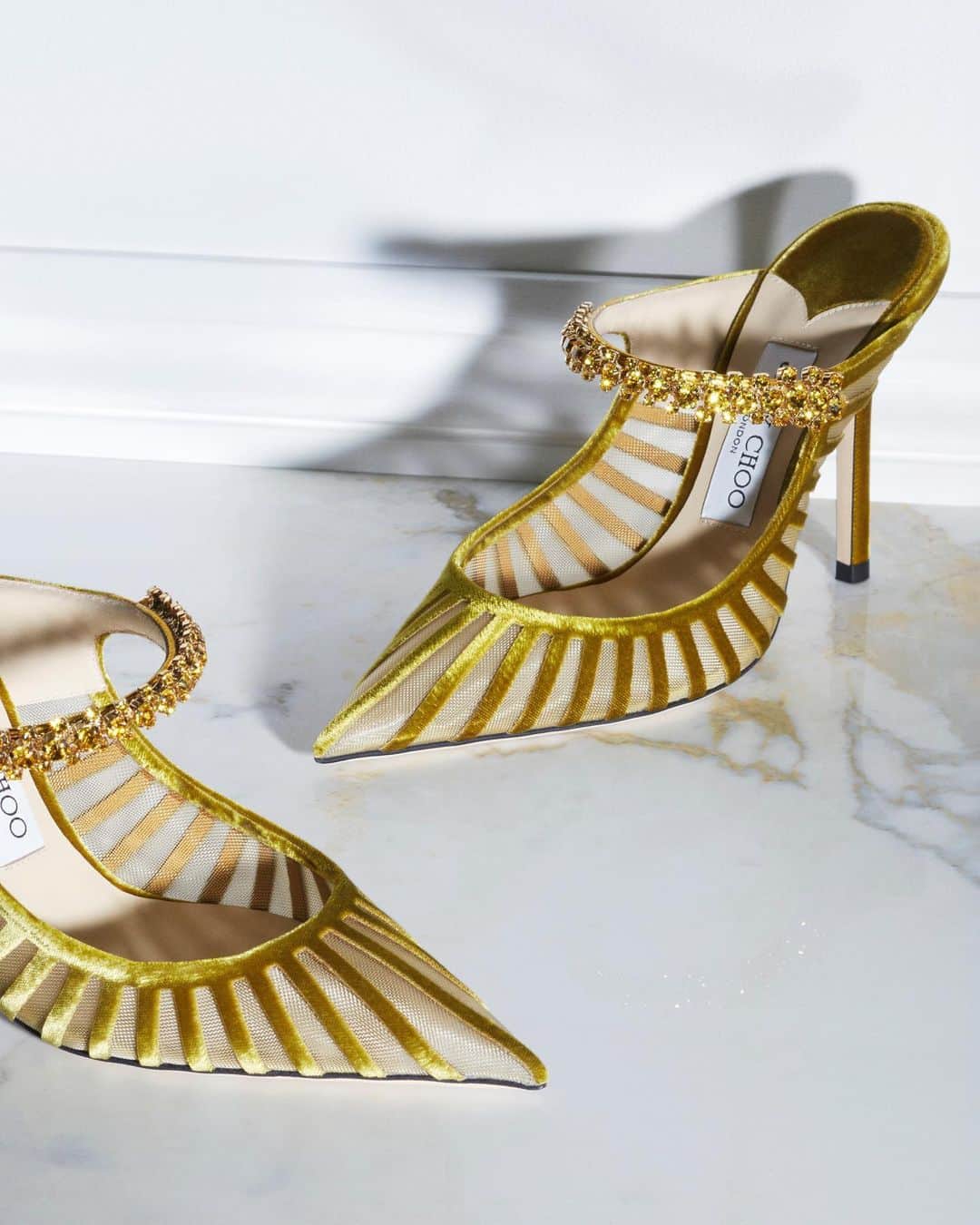 Jimmy Chooのインスタグラム：「This season's emphasis on glamour has inspired new additions to our collection of Icons - the Bing mule has been reimagined in striped velvet and finished with a tonal Swarovski crystal cuff #JimmyChoo」