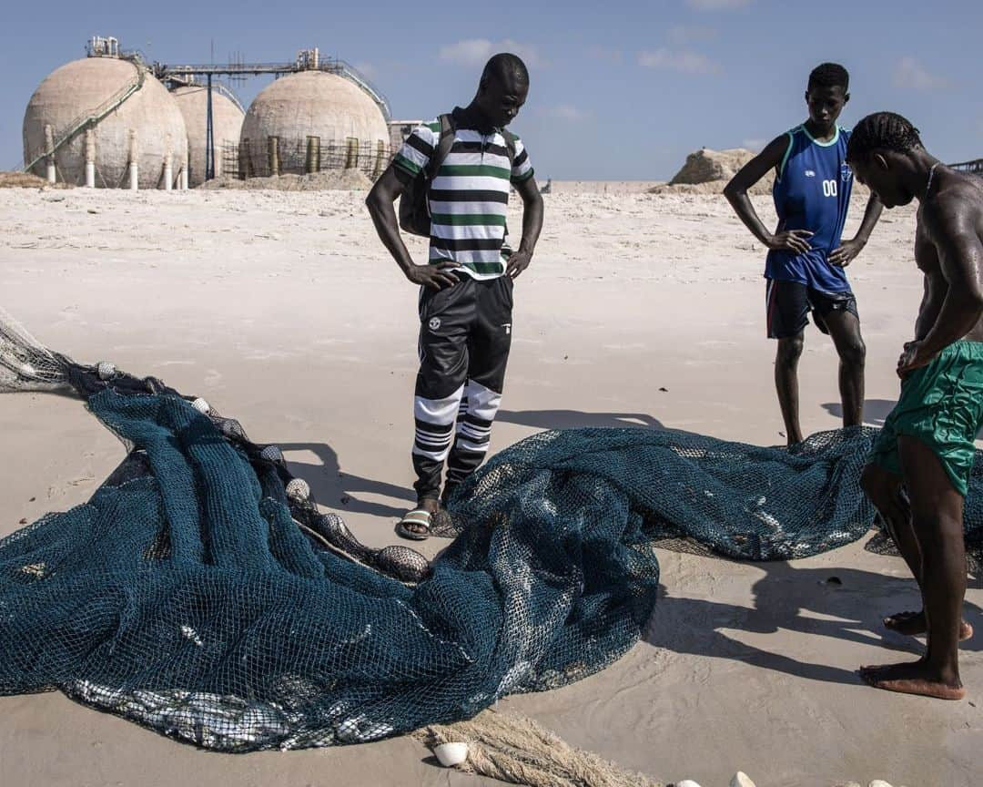 AFP通信さんのインスタグラム写真 - (AFP通信Instagram)「Dakar's Hann Bay: from idyllic coastline to industrial dumping ground⁣ ⁣ Hann Bay, which stretches around 14 kilometers, used to be known as one of the most beautiful bays in West Africa, lined with traditional fishing villages, villas, and tourist attractions. For the last 20 years Hann Bay has been at the centre of Dakar’s industrialization with 80 percent of the industry located in this area. Today it is one of Dakar’s most polluted areas, with canals spilling raw sewage and chemicals onto the beach and into the sea. A build up of plastic and materials penetrates meters deep into the sand. Some families have banned their children from swimming and using the beach. Many people fall ill with skin diseases, gastroenteritis and respiratory issues. The pollution has also effected the traditional fishing community, the bay used to be abundant with fish life but now fishermen have to travel further to find fish. ⁣ ⁣ 1 - A woman walks with her daughter along Hann Bay in Dakar.⁣ 2 - Yellow billed kites search for scrap along Hann Bay in Dakar.⁣ 3 - A man pulls material out of the sand during a beach clean up along Hann Bay in Dakar.⁣ 4 - A man walks with his two children past an excavator trying to clean years of built up pollution along Hann Bay in Dakar.⁣ 5 - Two men burn animal hides which will be dried out along the polluted Hann Bay in Dakar.⁣ 6 - A man stands in the ocean along Hann Bay in Dakar.⁣ 7 - A young boy walks over a canal with green liquid flowing to the ocean in Dakar.⁣ 8 - A young boy plays with a football next to a open sewage pipe along the polluted Hann Bay in Dakar. ⁣ 9 - Fishermen look on at the catch along Hann Bay in Dakar. ⁣ 10 - Fishermen prepare their boats for departure in the polluted waters of Hann Bay in Dakar. ⁣ ⁣ ⁣ 📷 @johngingerwessels⁣ #AFPPhoto」11月28日 21時01分 - afpphoto