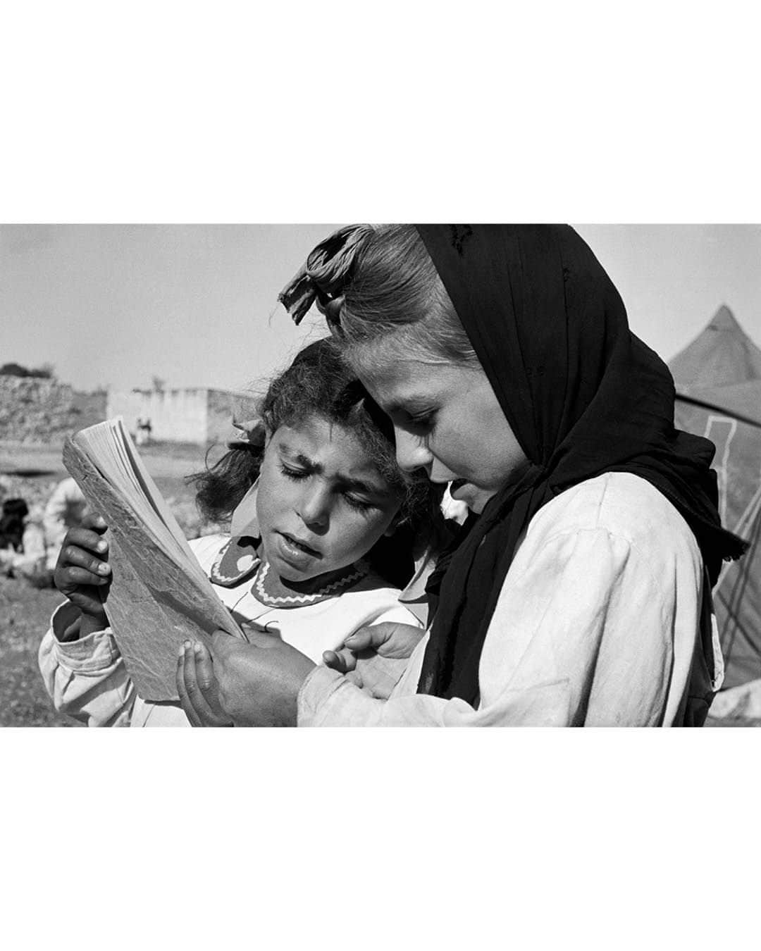 Magnum Photosさんのインスタグラム写真 - (Magnum PhotosInstagram)「A selection of images from the Magnum archive relating to Israel, Palestine and the surrounding areas, dating back eighty years.  Magnum photographers have covered several key moments in the decades-long history of conflict and tension between Israel and Palestine, starting with @philippe_halsman_official’s photographs from 1936 showing tension building in Mandatory Palestine and continuing up until October 2023, with recently published work by @william.keo, @jeromesessini and @pvanagtmael from Israel and the West Bank.  🔗 View the full selection at the link in the @magnumphotos bio.  Magnum Photos stands for the freedom of the press and against the targeting or silencing of journalists in the field.  PHOTOS (left to right):  (1) The British Army and Palestine Police force searching passers-by in Jaffa during the Arab Revolt. Jaffa. 1936. © @philippe_halsman_official / Magnum Photos  (2) Two Palestinian girls reading in a refugee camp in the Jordan Valley. Jordan. 1952. © @georgerodgerphotos / Magnum Photos  (3) Israeli soldier in East Jerusalem knocks out the Arab sign naming the Wailing Wall as “Al-Buraq Wall.” 1967. © @michabaram.archive / Magnum Photos  (4) Woman with a rifle guards a flock of sheep on a Kibbutz. Golan Heights. 1973. © @thomashoepker / Magnum Photos  (5) Palestinians demonstrate for peace with olive branches next to Israeli Border Guards. West Bank. 1991. © @abbas.photos / Magnum Photos  (6) Young Palestinian man loading stone into a homemade catapult. West Bank. 2000 © Larry Towell / Magnum Photos  (7) Palestinian evicted from his home (left) by the Israelis because of its close vicinity to the ‘Security’ wall. Bethlehem, West Bank. 2005. © @marktpower / Magnum Photos  (8) Funeral of Avraham Walz, 29, killed in an attack earlier that day by a Palestinian in a stolen digger. Jerusalem. 2014. © Peter van Agtmael (@pvanagtmael) / Magnum Photos  (9) Clashes between Palestinian youth and Israeli forces following US president Donald Trump’s statement on Jerusalem status. Ramallah, West Bank. 2017. © @paolopellegrin / Magnum Photos  (10) Front door of a house is pierced by bullets. Kibbutz Kfar Aza, Israel. 2023. © @william.keo / Magnum Photos」11月28日 23時02分 - magnumphotos