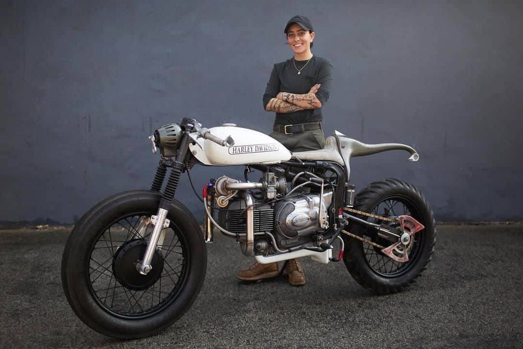 Harley-Davidsonのインスタグラム：「J. Shia's unconventional 1972 350cc Sprint custom is now on display at the Harley-Davidson Museum in Milwaukee, WI.​ ​ Inspired by Tchaikovsky's famous ballet "Swan Lake," J. designed a dual bike project to reflect both the contrast and parallels of the black and white swans. The "white swan" takes its place on display at the Museum.​  ​ J.’s build style for this project is unique in both function and materials, which she designed and fabricated all out of her Boston-based shop Madhouse Motors.​ ​ The swing-arm is stretched and fitted with a single-side suspension with a dual mono-shock system. The bike is outfitted with a turbocharger that utilizes a dual scavenge pump setup and an exterior oil tank hidden in the tail section. The battery is hidden inside the gas tank.​ ​ J. also incorporated unexpected parts from other products to create the bike. The headlight is the projector from a microscope and the tail light is a pencil sharpener. The carburetor intake is a modified juicer, and the foot-pegs are stove handles, while the turbocharger’s exhaust is a soprano saxophone bell.​  We're proud to display this amazing build as a symbol of ingenuity in moto customization.​ ​ #HarleyDavidson #HDMuseum」