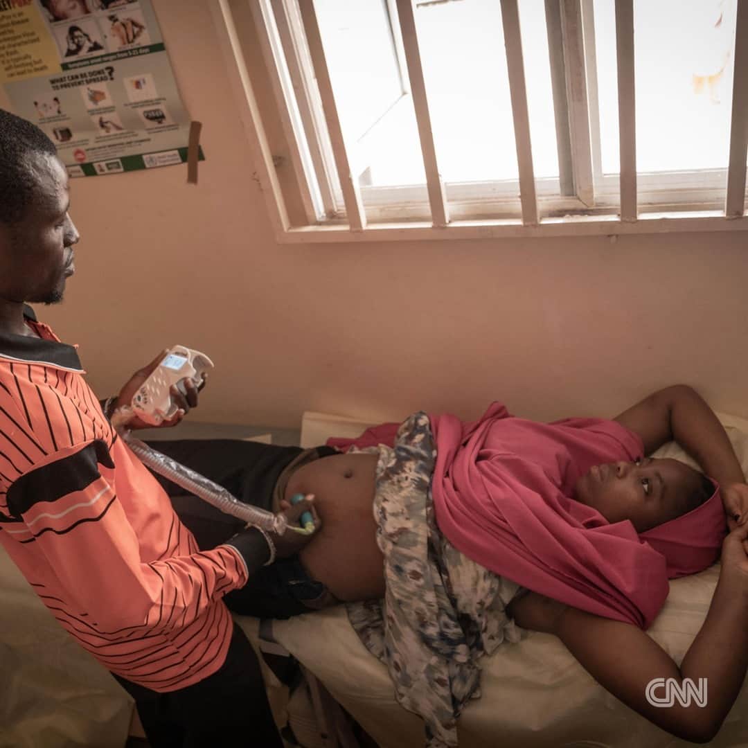 CNNさんのインスタグラム写真 - (CNNInstagram)「Aisha Aliyu is eight months pregnant and sprawled out on a mat in front of her house with four of her children spread around her feet. Two-year-old Hauwa and five-year-old Abba are both crying and tugging at their mother's hijab. She, in response, rolls her eyes and clicks her tongue at them. She looks tired.  The child Aliyu is carrying is her tenth. The last four were delivered in the Durumi Camp, a place in Nigeria's capital city, Abuja, that she and an estimated more than 3,000 other internally displaced people call home.  In 2013, Aliyu fled her home in the village of Wala in Nigeria's northeastern Borno State to its capital, Maiduguri. She said her village was attacked and much of it burned down by armed Islamist group, Boko Haram. Two years later, the militant group attacked Maiduguri, forcing Aliyu to again migrate, this time travelling over 856km south to Abuja with her husband and five children.  The now 39-year-old saw having many children as a way of replacing her relatives killed by the insurgents, but reveals she was done after her last pregnancy in 2021 and began using contraceptives. However, she became pregnant again this year.  Aliyu is one of many internally displaced women bearing children in Nigeria's camps, with some grounds not even housing a health post or shelter for birth, instead needing women to go into labor in their own shelters or that of their birth attendant.  Tap the link in bio for more.   📸 : Taibat Ajiboye for CNN  1. Aisha Aliyu. 2. The nurse takes the weight of the pregnant women during antenatal. 3. The camp nurse, Isa Umar examines a pregnant woman during antenatal session. 4. With Aisha almost full term, she is no longer able to go to fetch water and now has to pay up to N500 daily for it to be delivered to her home. 5. The makeshift delivery room partitioned in the shipping container used as the camp's health post. 6. A volunteer doctor brought his own kit to do blood tests at the Durumi camp. 7. Aisha with five of her children.」11月30日 1時08分 - cnn