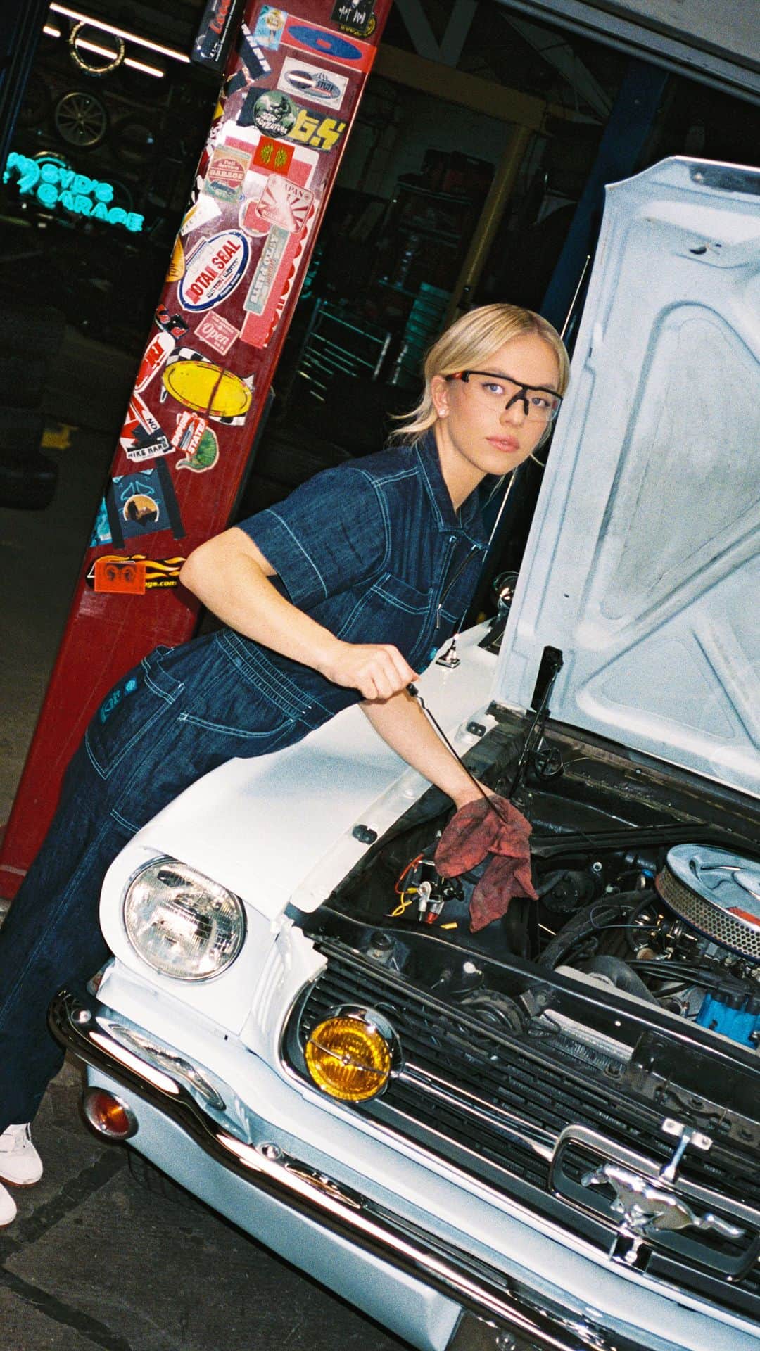 Fordのインスタグラム：「Spend a day in the garage with @sydney_sweeney as she does some maintenance work on her vintage Ford Mustang®. Want to shop the look? Limited-edition coveralls are up on the IG shop now.」