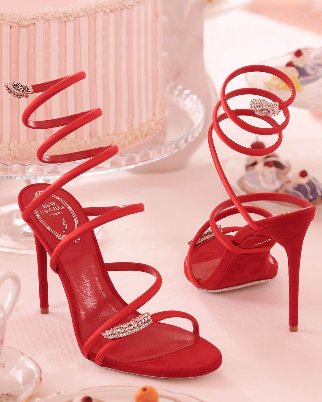 レネカオヴィラのインスタグラム：「Unlock your desire for luxury as you step into the glamour of the Serpente sandal with precious diamond appliqué in a dazzling festive-red shade.  #ReneCaovilla」
