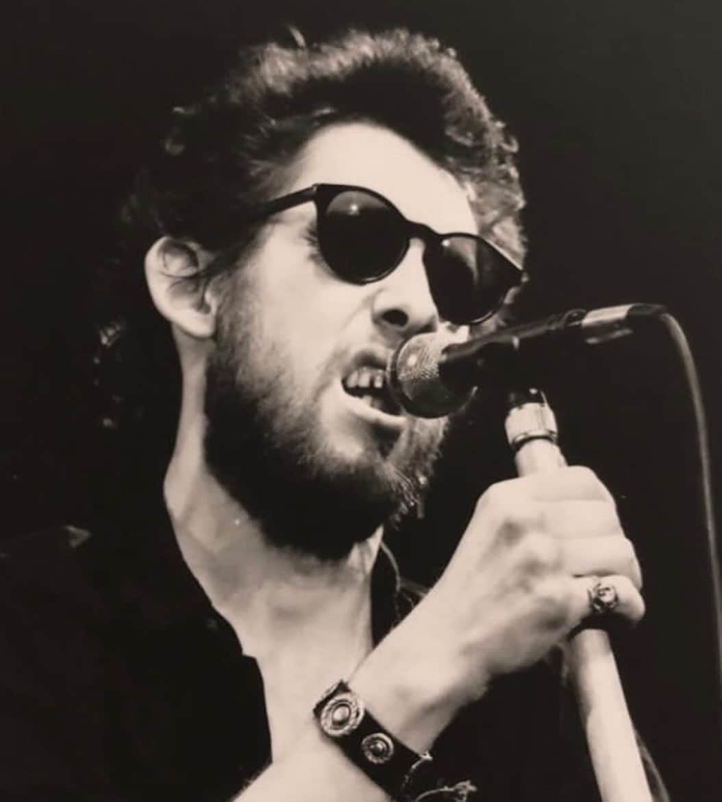 ポール・ブラックソーンのインスタグラム：「The 80’s was a wierd place to grow up, all big, bright, bouncy and poppy. Never really my jam. Thank God this man, in a lank old raincoat, one hand hanging off the end of a mic stand, the other hand wrapped round the neck of a whisky bottle was there to save us. The man that lit up the 80’s like a stubbed out cigarette stood, just about, on many a stage way back when. Haunted by something that dragged these words and tunes from his heart and bones onto a crowd that never could get enough of his alleyway tales of women, drinking and faraway lands. Perfect fodder for this teenage boy looking for somewhere to run and somewhere to hide.  “I'm sad to say I must be on my way. So buy me beer or whiskey, 'cause I'm going far away. I'd like to think of me returning when I can. To the greatest little boozer and to Sally MacLennane”  After the moshing, the drinking, the pogoing, the sweat, we’d wait for the crowd to clear out, see what was left on the floor; broken watches, coins and the odd fiver if we got lucky. Then peg it for the last train home.  “Lend me 10 pounds and I’ll buy you a drink and mother wake me early in the morning”   And back we came each time, to see this ramshackle genius and his horde of drunken vagabonds trouncing ‘round the stage dishing out this unbridled swill of Irish spirit. These mad, beautiful songs galloping through sticky, smoky 80’s air, far far away from gawdy shoulder pads and puffed up hair.  Thank you Shane for the gut punch words and lumps in the throat.  Thank you Shane for the mad, beautiful, marauding music.  Thank you Shane for some of the best memories of my teenage years.  “In blood and death 'neath a screaming sky I lay down on the ground And the arms and legs of other men Were scattered all around Some cursed, some prayed, some prayed then cursed Then prayed and bled some more And the only thing that I could see Was a pair of brown eyes that was looking at me But when we got back, labeled parts one to three There was no pair of brown eyes waiting for me”  RIP Shane MacGowan. X」