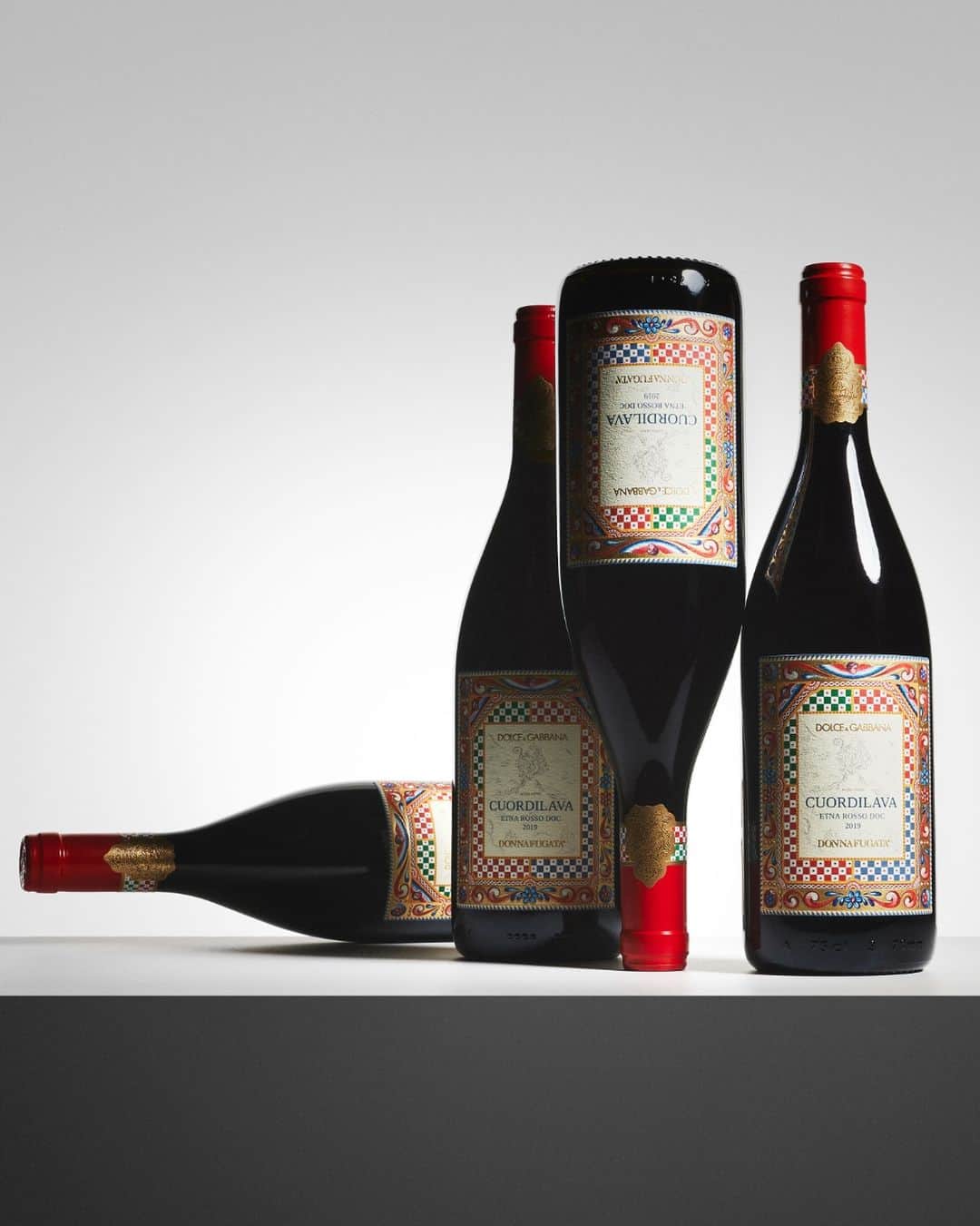 ドルチェ&ガッバーナのインスタグラム：「Sip into the essence of Sicily with Cuordilava by #Donnafugata, a prestigious red wine produced on the slopes of Mount Etna.  Tap into an extraordinary gifting experience with #DGHolidays on dolcegabbana.com   #DGVino  #DonnafugataWine」