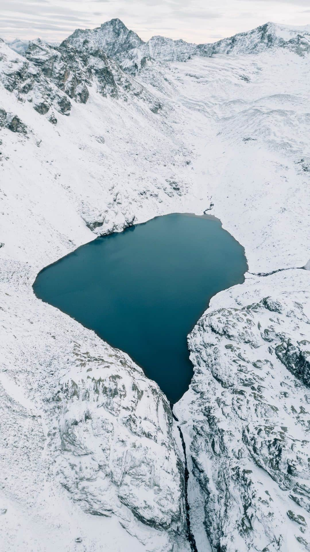 IWCのインスタグラム：「Ice-cold lakes, crisp white snow. More than 2,400 meters above sea level and offering stunning panoramic views, Sarganserland is the next stop on our journey to the source of the Rhine with @thealpinists. Our chosen watch for this pristine alpine landscape: the Big Pilot’s Watch Perpetual Calendar TOP GUN “Lake Tahoe” (Ref. IW503008), engineered in pure, snow-white ceramic.  🔗Link In Bio  #IWCHolidaySeason | #IWClaketahoe | #TheOriginOfTime | #IWCPilot」