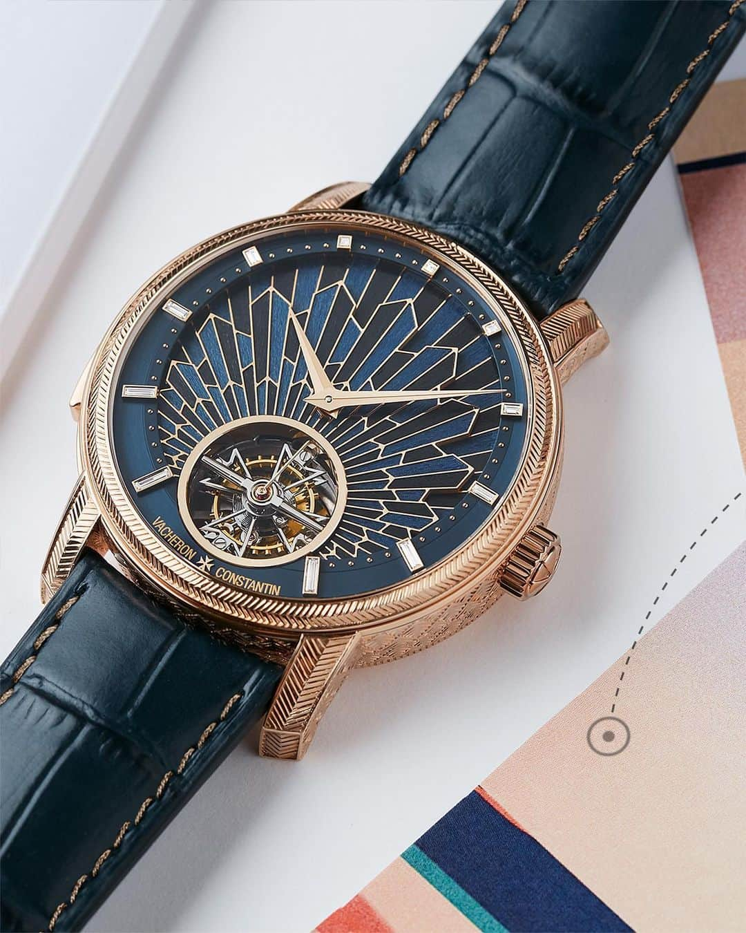 ヴァシュロン コンスタンタンのインスタグラム：「A unique architectural splendour 🔥  Lay your eyes on a masterpiece where architecture meets horology: the new Les Cabinotiers Minute Repeater Tourbillon, a single-piece that revisits the Art Deco splendour of New York’s Chrysler Building.  This dial is a first-of-its-kind, marrying wood marquetry with the rich hues of champlevé enamelling. Crafted with 110 precise pieces of pearwood and tulipwood, the marquetry took an entire month of dedicated artisanship.  The pink gold case, entirely engraved with herringbone motifs, echoes the Roaring Twenties' bold creativity.  Beating within is the exquisite manual-winding 2755 movement, fusing the lyrical beauty of a minute repeater with the meticulous precision of a tourbillon.  Join the odyssey of our Récits de Voyages at the link in bio.  #VacheronConstantin #OneOfNotMany #oneofakind #vacheron #thehourlounge #watches #watch #watchesofinstagram #horology #watchoftheday #instawatch」