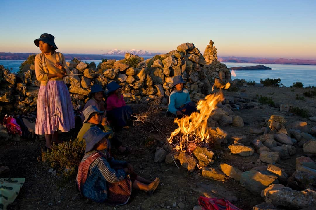 Robert Clarkのインスタグラム：「A group of teenagers warm themselves by a fire at the end of the day on Island del Sol (Island of the Sun ), Lake Titicaca, Bolivia. The island is the home of the greeting myth of the Inca.  Island del Sol (Island of the Sun ) at Sunset, on Lake Titicaca, Bolivia   #islanddelsolislandofthesunlaketiticacabolivia #peru #inca #mm_7808_inca #robertclark #robertclarkphotography」