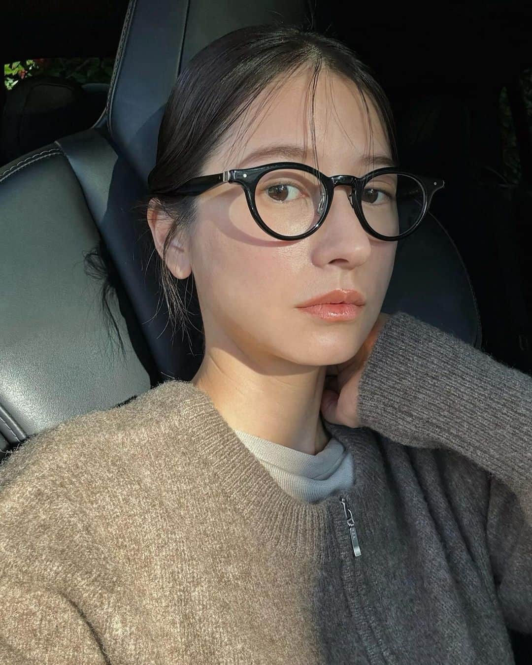 松本恵奈のインスタグラム：「おはようございます。 今日は学校が1限ですぐ帰ってくるから送った後、 駐車場でそのまま待機してるんだけど太陽が出てきて 大ピンチ！！ 暑いし隠れる場所がないのでひたすら我慢。笑  そしてやること無さすぎたので朝ごはん食べたり 自撮りとかしてみたりして暇つぶししています🤳😂 今日は化粧ほとんどしてないので伊達メガネ。 こーいう時に便利だよねー👍🏻 私服はYAK KNITだよ！ #私服 #clane」