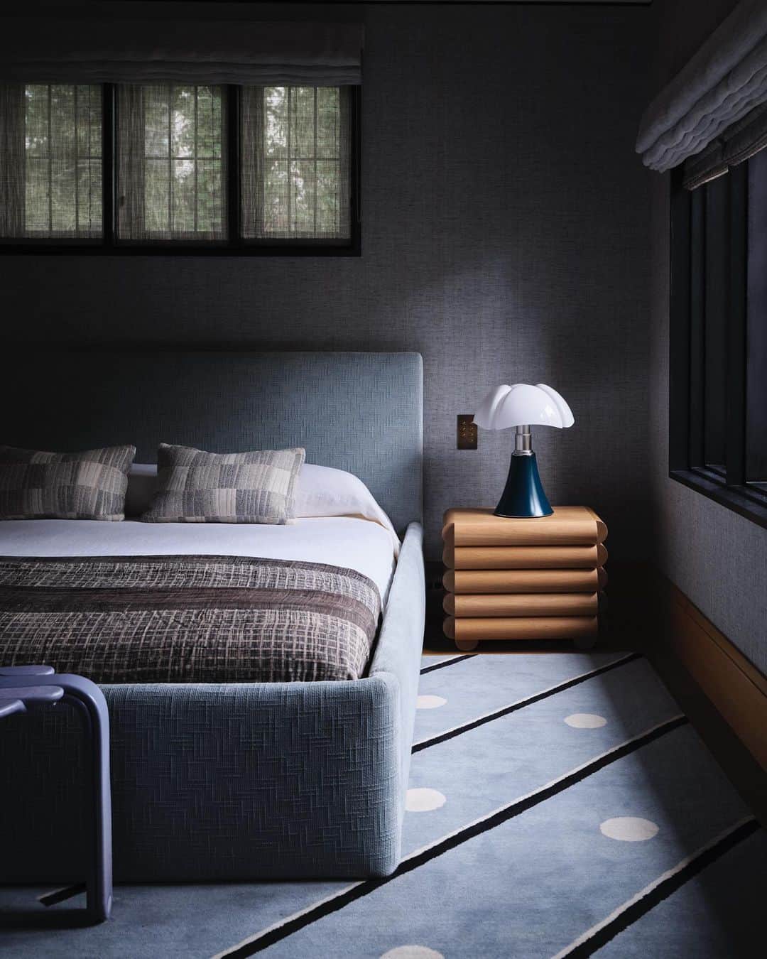 ケリーウェアスラーのインスタグラム：「CHARM AND CHARACTER I love designing inspiring kids room for clients…a space to stimulate and kindle their child’s imagination. This inviting bedroom bathed in a smoky blue hue, presents the perfect blend of charm and sophistication for a little boy to grow into. A playful carpet, inviting imagination and fun, while providing a cozy foundation for the design of the room. Artistic side tables, made from rich timber, add a touch of thoughtfulness with their rounded forms and shapes. For storage, we chose a credenza by USM in a soft heather gray to store lots of fun, above an over sized mirror by artist Amelia Briggs and a vintage round disc lamp from the 1990’s that speaks to the shapes in the carpet. Throughout the room, a harmonious mix of vintage and contemporary pieces creates a timeless look. XK」
