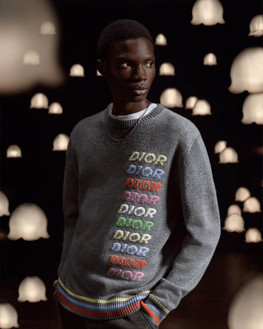 クリスチャンディオールのインスタグラム：「Illuminating magical wintry scenes, a constellation of bells of lily of the valley, the founding couturier's lucky bloom, light up a series of must-haves from the #DiorSpring24 collection by @MrKimJones with grace and magic. From the #DiorB57 sneakers and the 'Dior 8' backpack to a snug Dior-gray sweater striped with the multicolor 'Dior Multi' signature repeating the House name, click on the link in bio to browse the full selection. © @AxelMorin_ and @RomainRoucoules」