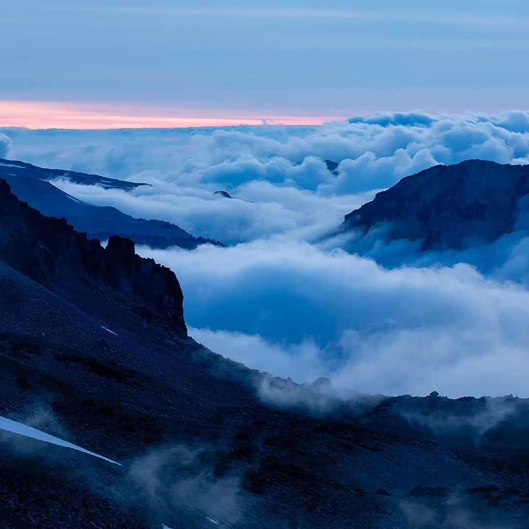 National Geographic Travelさんのインスタグラム写真 - (National Geographic TravelInstagram)「Photos by @stephen_matera | You might call it dusk or twilight, but photographers call it the blue hour. And for good reason. The color in this photo comes not from filters or Photoshop but from the color of the light that occurs naturally after the sun has set. Our brain will fool us into not seeing it, but the camera records the color of the light objectively. And here, the color adds to the mood of the clouds hovering around the mountains of the Central Cascades in summer, Mount Rainier National Park, Washington.   Follow me @stephen_matera for more images like this from Washington and around the world.」12月5日 8時50分 - natgeotravel