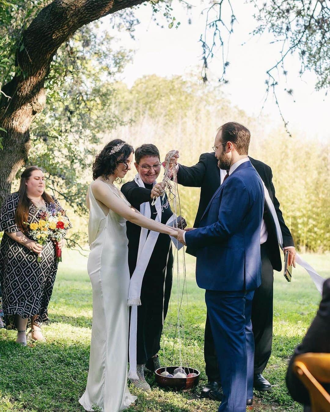 シャロン・ローレンスさんのインスタグラム写真 - (シャロン・ローレンスInstagram)「Our family is so happy for my lovely cousin Camille, and her equally lovely husband, Noah. Let them warm you with their wedding joy.   ❤️Repost- @camille__martine  Oh November, you were so filled with love from every direction — childhood friends, loved ones, neighbors, and teachers who have seen us through every phase of life. The weather was perfect, the food was divine, and the dance floor was epic—iykyk!  In 2011 when my mom died, I made one of those promises you make to yourself when you are very young and dealing with loss for the first time that I’d keep her memory alive and never leave her behind. It hasn’t always been the easiest (or healthiest) and the weekend before our wedding was very hard. I worried a lot about how so much joy and grief would be able to co-exist.   One of the greatest gifts was having family and friends work together to ensure my mom’s presence was felt. Her name was on the lips of so many all day and all night. Our pastors, who I grew up with and ministered to my mom, brought skeins of my mom’s yarn that she had donated to the church. During the ceremony everyone tied knots in the yarn and then it was placed over our hands for a blessing. I wore the simple gold chain she wore every day of my life growing up and carried the clutch she had on her wedding day. All week, my family, in-laws, bridesmaids, and friends showered me with love and filled in the painful gaps.  How lucky I am to be surrounded by people who know how hard this grief is to carry and who will step in and help you carry it. Thank you. ♥️  📸 @leeannfunkphoto」12月5日 14時09分 - sharonelawrence