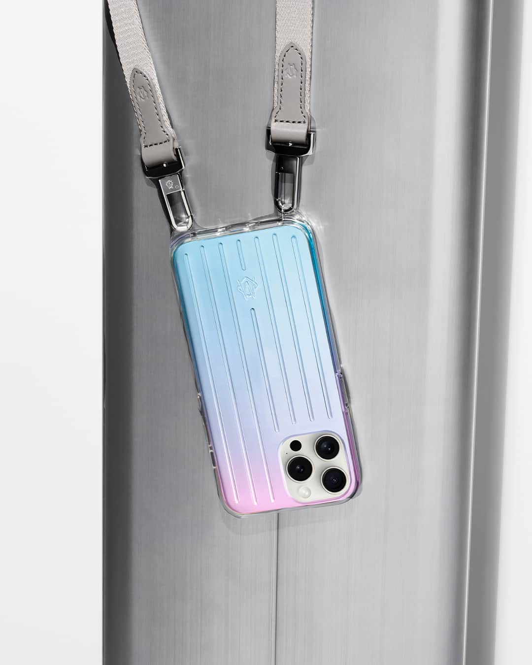 リモワのインスタグラム：「Always within reach — the RIMOWA Iridescent Polycarbonate iPhone 15 Pro Case with Strap.」