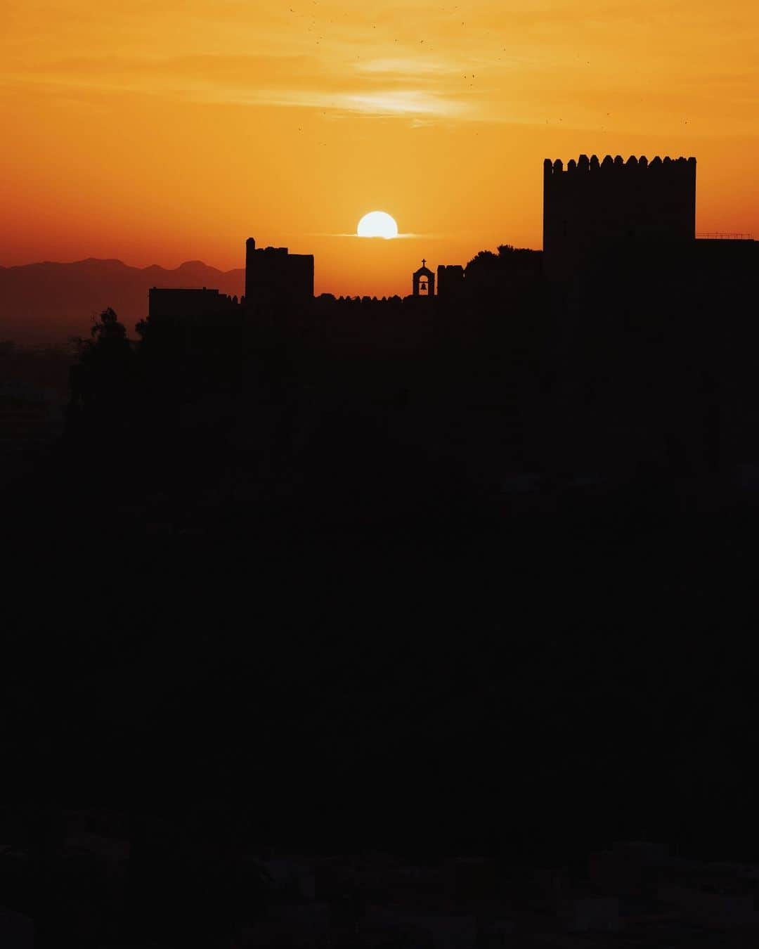 Alex Strohlのインスタグラム：「Time traveling in Andalusia… I was treated to the regions legendary sunrises a few days ago while on a morning walk through a completely unknown neighborhood of Almeria.  I knew that I would get a nice view of the Alcazaba Castle and that the sun should rise behind it but when we headed out it was pretty overcast and there was low hope for the sunrise I dreamt of. As it is often the case, you never know, because the sun peaked exactly where it should have had and I was exactly at the right spot.   Gracias, Almeria.  #framesofandalucia」