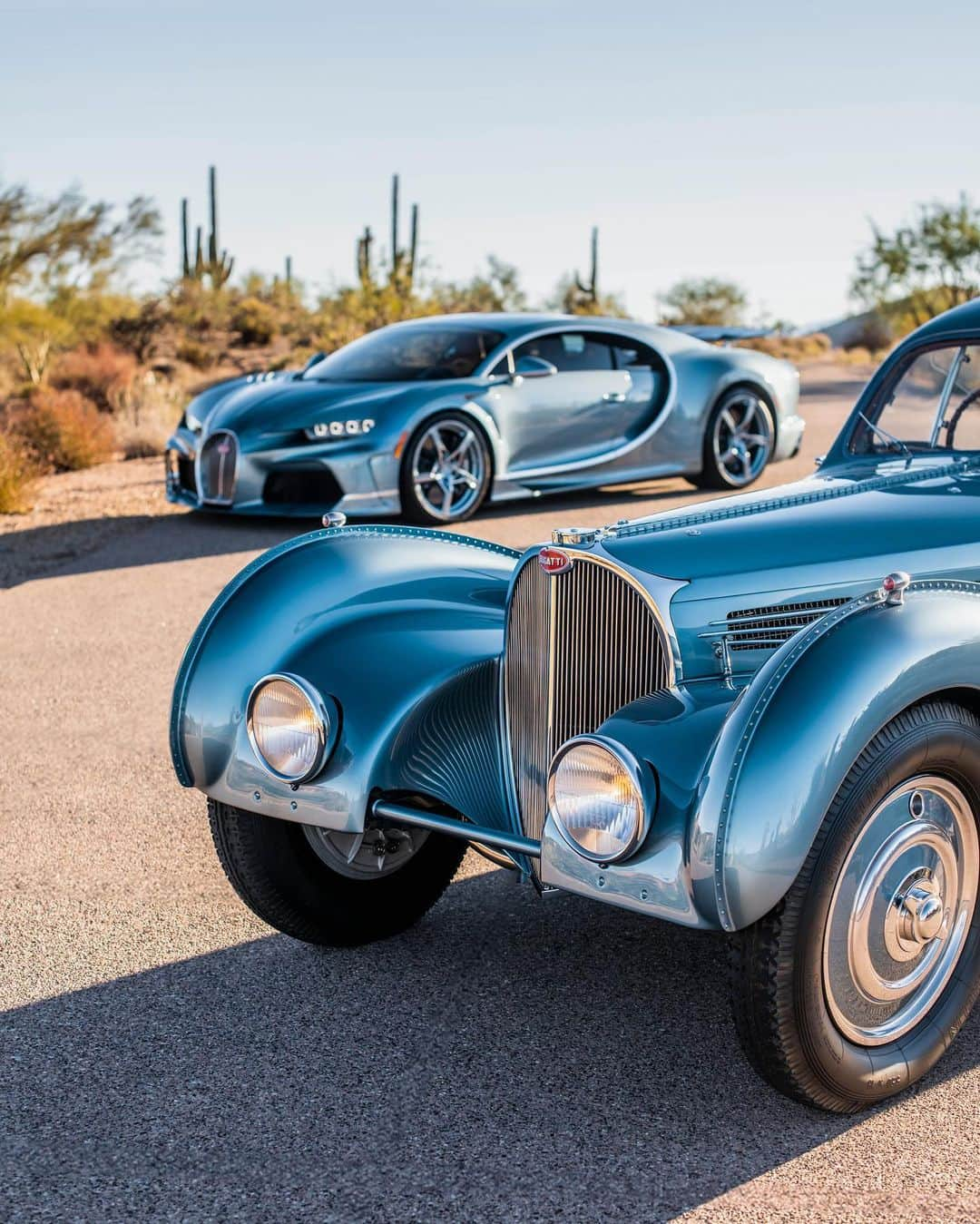 ブガッティさんのインスタグラム写真 - (ブガッティInstagram)「We celebrate a rare moment in automotive history: The CHIRON Super Sport ’57 One Of One’, BUGATTI’s most recent ‘Sur Mesure’ project, meets its paragon, the BUGATTI Type 57 SC Atlantic nearby the home of its current owner in the desert of Arizona.  It has been a lifelong dream of the CHIRON’s new owner to pay homage to the Atlantic, which she calls the most beautiful car in the world since she first saw it in the @MullinMuseum in Oxnard, California.   Now she finally achieved her goal with the creation of her CHIRON Super Sport that reinterpreted the iconic model – a birthday gift from her husband. “Everything is so perfect. I especially love how the colours match,” she adds full of admiration.  Co-created with the ‘BUGATTI Sur Mesure’ team, the development of the ‘57 One Of One’ was a labour of passion that stretched over a year.  #BUGATTI #CHIRONSuperSport #BUGATTISurMesure – WLTP: bugatti.link/consumption」12月9日 0時12分 - bugatti