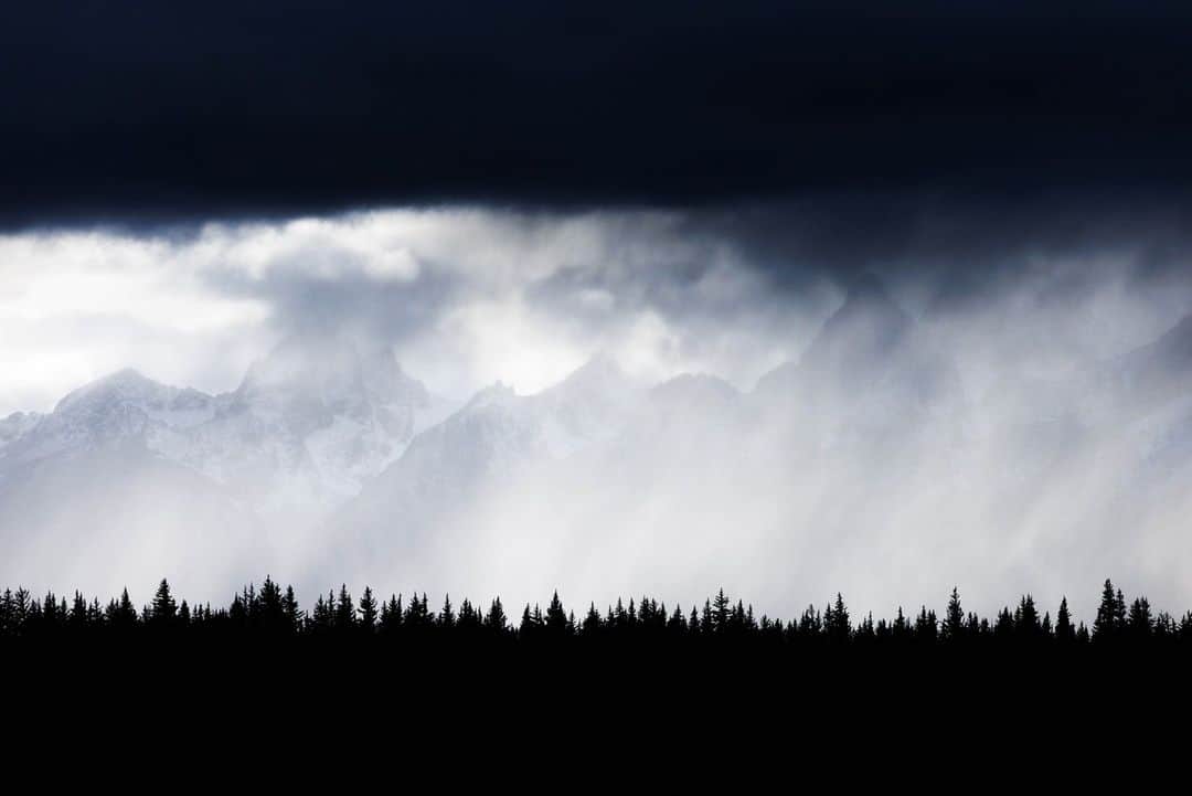 National Geographic Travelのインスタグラム：「Photo by @sofia_jaramillo5 | Clouds lift over Wyoming's Teton Range on a stormy day. For me, fall is a favorite time here, with brightly colored trees lighting up landscapes across the mountains and animals like elk migrating to their winter homes. For more images of the Tetons, follow @sofia_jaramillo5.」