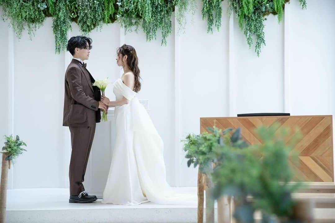 JUNO TENJINさんのインスタグラム写真 - (JUNO TENJINInstagram)「Real Wedding  weekendhouseにて 挙式を挙げられたお客様より 素敵なお写真が届きました🕊️  白を基調としたシンプルな空間に たっぷりとあしらわれたグリーンが印象的な あたたかみのあるチャペル  ご新婦様のおしゃれな雰囲気にぴったりの すっきりとしたシルエットのドレス  雰囲気を変えられるオフショルダーは 取り外しも可能ですので ご自身らしさを表現できます。  ご新郎様はブラウンのタキシードを合わせ おしゃれなお二人のコーディネートが とても素敵な一枚となりました🕊️  #junowedding  #juno  #wedding  #weddingdress #realwedding #ジュノ #インポートドレス福岡　 #ジュノウェディング  #ウェディングドレス #カラードレス  #ウェディングドレス迷子  #カラードレス迷子　 #ドレス試着  #運命のドレス探し  #プレ花嫁  #九州花嫁  #九州プレ花嫁  #福岡花嫁  #福岡プレ花嫁  #2023秋婚  #2023冬婚  #2024春婚  #junoの前撮り  #juno天神本店」12月10日 20時00分 - juno_tenjin