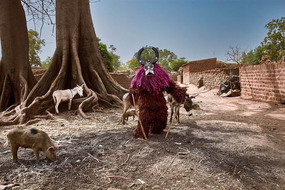 thephotosocietyさんのインスタグラム写真 - (thephotosocietyInstagram)「Photo by @aitorlaraphoto // Masks hold an ontological status of utmost transcendence within the African cultural tradition; they are not merely profane representations. In Africa, the mask is the most significant embodiment of the hidden and enables the connection between the living, the dead, and the invisible spirits. They perform various and important social functions within communities, within a sacred, religious and even political context. The Kôro masks are a reincarnation of Dwo, the invisible deity of the Bwa ethnicity of Burkina Faso. They emerge during the months preceding the rainy season. The mask bearers entirely cover their bodies with leaves and plush. Some do not appear for years, as they are only invoked in extraordinary situations. The secret societies of masks and the religious leaders of the African tradition zealously and proudly preserve their belief system and ancestral mythology against external threats. The caste of the Griot is intimately linked to the secret society of masks as dance, music, and their instruments are the vehicles through which the stories and messages of the sacred are conveyed.」12月12日 8時37分 - thephotosociety