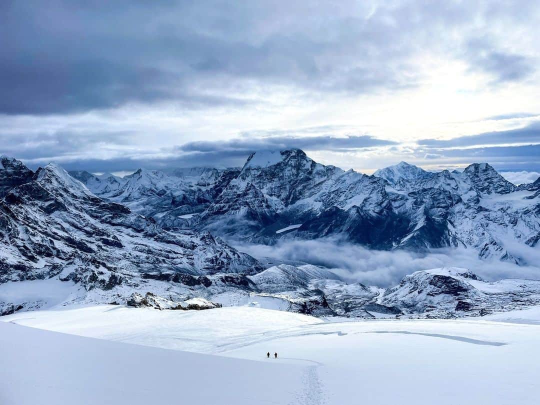 National Geographic Travelのインスタグラム：「Photo by @erintrieb | Among the many things I love about climbing big peaks are the weather patterns and color shifts that appear through my lens in a single day. Misty clouds glow pastel pink with the morning sunrise, while hues of icy blue and deep shadows outline snowcapped peaks by midday. Clouds can engulf a slope, causing whiteout conditions with no sight of the horizon, but 10 minutes later the sun can appear, to create perfect bluebird weather. For me, the mountains are the ultimate educator as they provide a flux of constant change and teach me to prepare, adapt, and continue moving forward.  In this image, on Mera Peak in Nepal, climbers descend the glacier’s northeast-facing slope at about 20,000 feet (6,100 meters). #InternationalMountainDay」