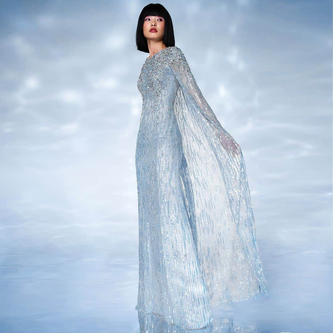 ジェニーパッカムのインスタグラム：「Atlantis in a sparkling, silvery blue with cape detail. Resort Spring Summer 24 collection. In store and online now.  #jennypackham #spring #summer #resort #cruise #paris #milan #newyork #london #hollywood #dress #awards #redcarpet」