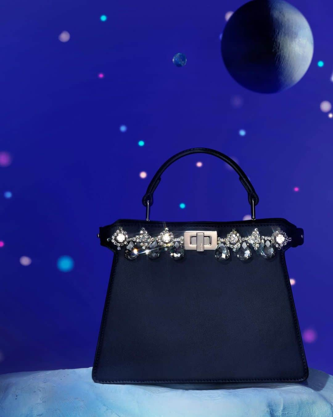 Fendiのインスタグラム：「A midnight blue #FendiPeekaboo is illluminated with a dazzling array of crystals and rhinestones in the #FendiGifts selection.  Find unforgettable pieces in boutiques and at the link in bio.  Photography: @_miloreid_ Set Design: @tilly_power33」