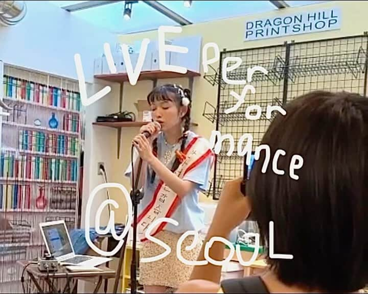 木越明のインスタグラム：「9月にやった韓国・ソウルでのライブ🇰🇷‼️  最高でした！！！ 人生2度目のライブがまさか海外でとは、思いもよらなんだ〜  自分の曲を幾つかと 韓国語の曲をサリさんに韓国語訳してもらいながら一緒に作ったの、歌いました (タスキには韓国語でnice to meet youって書きました)  サリさんのオタマトーンで踊る時間…あんなに楽しい事、この世になかなかない 最高に自由なよろこびの舞でした🗽  お客さん皆暖かくて、終わったあとに嬉しい事いっぱい話しかけてくれて、ロシアから来たユリアちゃんはチョコレートケーキをくれました(めちゃくちゃ美味しかった！) @gladkihihihih   韓国でやりなよと声をかけてくれた @y00nkeekim さん本当に有難う！ すごく素敵なお店でライブさせてくれて有難う、 @dragonhillprintshop @fuckyouiworkfortraitor  そしてサリさん… ブラックピンク並の怒涛のスケジュールの最中も、私がパスポート無くして深夜の公園で号泣しても、一緒に楽しく過ごしてくれたサリさん。 全ての最高な瞬間はサリさんのおかげでした @sariokura   全然知らない土地で、自由で楽しい気持ちになって、友達になってくれた人もいて、沢山嬉しかったな〜ソウルツアー 世界中にはたくさん楽しい人と場所があるって思うので、来年もたくさん遊びに行きたい！  ……………………………………………  Live in Seoul, Korea, which we did in September🇰🇷‼️  What a good feeling it was! I had no idea that the second live show in my life would be held overseas.   I sang some of my songs that I wrote in Japanese and English. I also sang a new Korean song that I wrote with the help of Korean translation by Sari. Dancing on her OTAMATONE... I can't think of many moments in this world that are as enjoyable as this one. It was really free and a great joy moments! (I wrote "nice to meet you" in Korean on the sash)  All the guests who came were warm and friendly, they talked to me after the gig, and Yulia from Russia gave me a chocolate cake. (It was so delicious! Спасибо! @gladkihihihih )  Thank you so much, @y00nkeekim for inviting us to play in Korea! Thank you @dragonhillprintshop / @fuckyouiworkfortraitor for letting us perform at your very pretty place! And @sariokura … Even when I lost my passport and cried in the park in the middle of the night, she was there to enjoy my time with me.  I owe all of my many impossibly fun moments in Seoul to Sari!  Trying to do something you don't know how it will turn out, in a place you don't know well… There are so many funny things, places and people in the world, and I want to visit many more next year!🌏🌤️🐛」