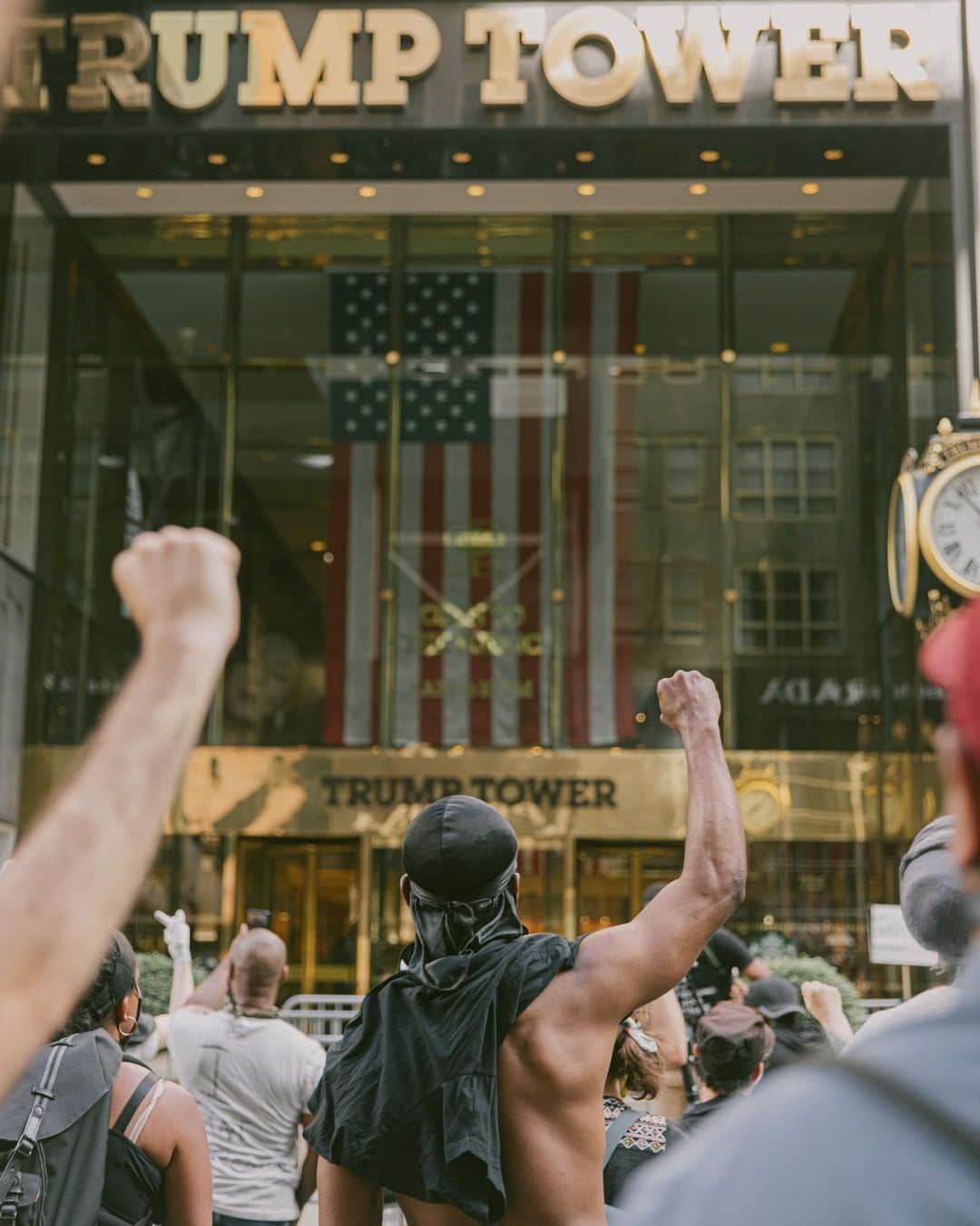 TIME Magazineさんのインスタグラム写真 - (TIME MagazineInstagram)「On May 30, five days after George Floyd’s killing in Minneapolis, Mark Clennon went out to photograph a peaceful protest winding through Manhattan. "Walking further down Fifth Avenue, I knew Trump Tower was ahead, so I hopped on a Citi Bike and cycled to the front of the crowd. When people got there and noticed it was Trump Tower, the whole protest stopped," says Clennon, 32. "I had never noticed the flag inside the Trump Tower all the times I passed it before, but in that moment, I was an active participant in that protest. I’m chanting, too, and my fist is up. The American flag behind the glass, in that gold, gilded case, it’s inaccessible to me. I have an urge to just break through that glass because that flag is for me, too. That’s the visceral feeling I had when I noticed the flag, and I think that’s the feeling this man had when he saw it, too." Read the full story behind the photo at the link in bio. Photograph by @mark.c」6月2日 23時42分 - time