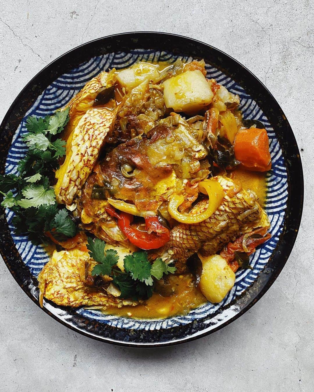 鄭碧瑩のインスタグラム：「Fish Molee  Still too weak to cook so @kvijaynathan took over the stove. Whole red snapper from @dishthefishsg cooked gently without heavy spices to mask its fresh flavor.  Looks like he nailed his grandpa’s recipe on his first attempt. @magesmuthiahvelan would be proud he says.  #stayhome #cookmore #eatwell everyone! . . . #indianfood #indiancooking #mollyfish #homecooking #sghomecooks #thefeedfeed #seafood #fishcooking #f52grams #sgcircuitbreaker #circuitbreaker #sgfood」