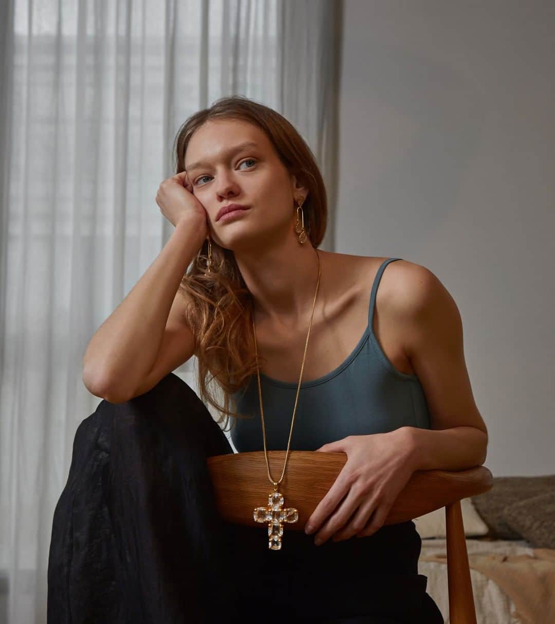 のインスタグラム：「CACHEMIRE earrings and STONE cross necklace in brass soaked in a 24-carat gold bath, yellow gold color, adorned with natural rock crystal cabochons. In a «raw» spirit of the material, the pieces of the STONE collection are adorned with beautiful semi-precisous stones, hand-cut in an emerald shape.」