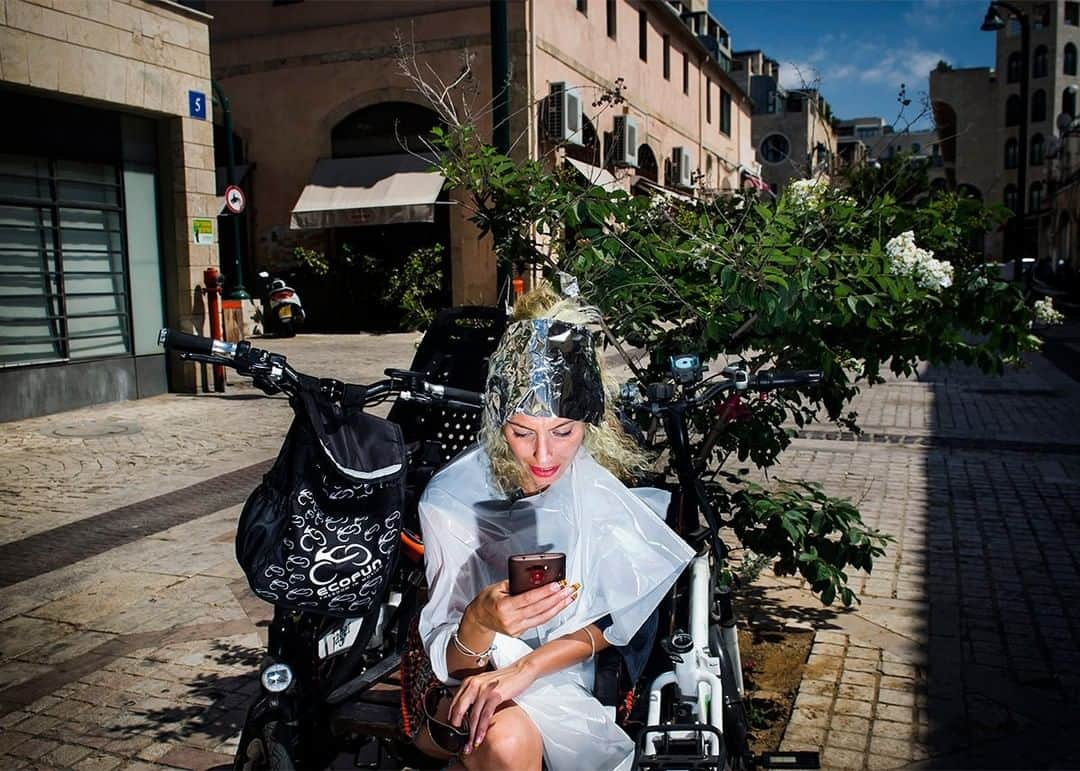 National Geographic Travelさんのインスタグラム写真 - (National Geographic TravelInstagram)「Photo by @dina_litovsky | A woman sits outside a hair salon in Jaffa, the oldest neighborhood of Tel Aviv, Israel. I love wandering Jaffa’s cobblestone streets and stumbling onto little moments like this. For more images, follow me @dina_litovsky.」5月14日 21時07分 - natgeotravel