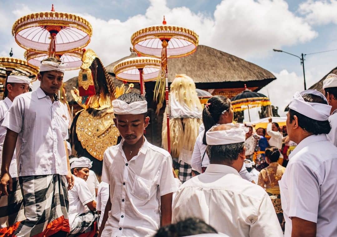 National Geographic Travelさんのインスタグラム写真 - (National Geographic TravelInstagram)「Photo by @joshuacogan | Devotees leave a temple in Ubud during the celebration of Galungan, the initiation of the festival calendar year here in Bali. It is one of the most important ceremonies on the island, and it opens a 10-day window in which the spirits of the ancestors come down to visit their homes. It also celebrates the victory of dharma (goodness/kindness/order) over adharma (evil/chaos). As such, it is a period of deep purification, prayer, reflection, and realignment.  In Balinese Hinduism, the struggle between dharma and adharma is less binary and more thought of as rebalancing. It is believed that we all have both elements within us, and it is impossible to be pure. Our job is simply to seek to increase the balance in favor of kindness and compassion. As such, rituals and offerings of abundance are placed at every home, altar, and temple.  To see more explorations of culture, faith, and ecology follow me @joshuacogan.」5月16日 1時06分 - natgeotravel