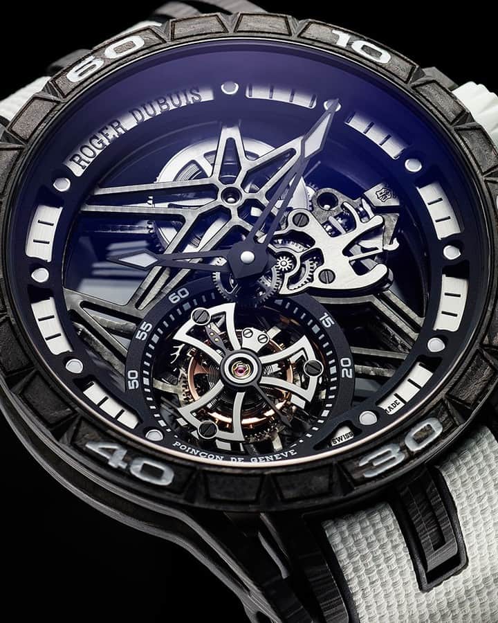 Yoshida 東京本店さんのインスタグラム写真 - (Yoshida 東京本店Instagram)「【ロジェ・デュブイ×YOSHIDA】新進気鋭のスイス高級時計ブランド「ロジェ・デュブイ」。こちらはモノトーンのデザインに、スケルトンムーブメントの迫力が際立つYOSHIDA限定モデル。極限までパーツを削ぎ落とした星型のスケルトンムーブメントは、複雑で美しい構造でありながら時計としての機能性も兼ね揃えています。﻿ ﻿ 品番：RDDBEX0801﻿ エクスカリバー スパイダー﻿ フライングトゥールビヨン スケルトン﻿ 限定28本﻿ ﻿ 商品詳細はプロフィールリンクの弊社ウェブサイト⇒メニュー「MEN'S」⇒「ロジェ・デュブイ」⇒「YOSHIDAスペシャルモデル」よりご覧ください。﻿ ﻿ お問合せは @yoshida_watch まで﻿ ————————————﻿ YOSHIDA 東京本店﻿ 東京都渋谷区幡ケ谷2-13-5﻿ TEL: 03-3377-5401﻿ ———————————— ﻿ #RogerDubuis #ロジェデュブイ #YOSHIDA限定 #Excalibur #エクスカリバー #Tourbillon #トゥールビヨン #YOSHIDA #ヨシダ #watch #高級時計 #腕時計 #時計」5月28日 12時00分 - yoshida_watch