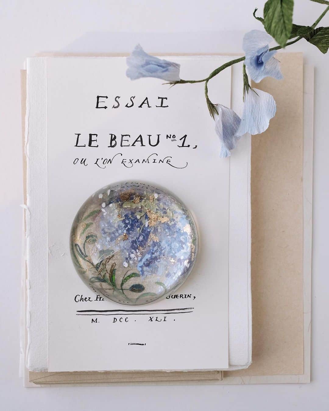 のインスタグラム：「Personalized hand painted paperweight for a wedding anniversary gift that holds a special memories of when the couple first met and a memorable wedding in Florence during Wisteria season. — #paperweight #domeproject  #truffypi #painting #madetoorder #mixmedia #pastel #glass #calligraphystyling #tabletop #stationery #カリグラフィースタイリング  #artobject #waterdrop #bespokestationery #florence #tokyo #wisteria #olivetree #italianwedding」