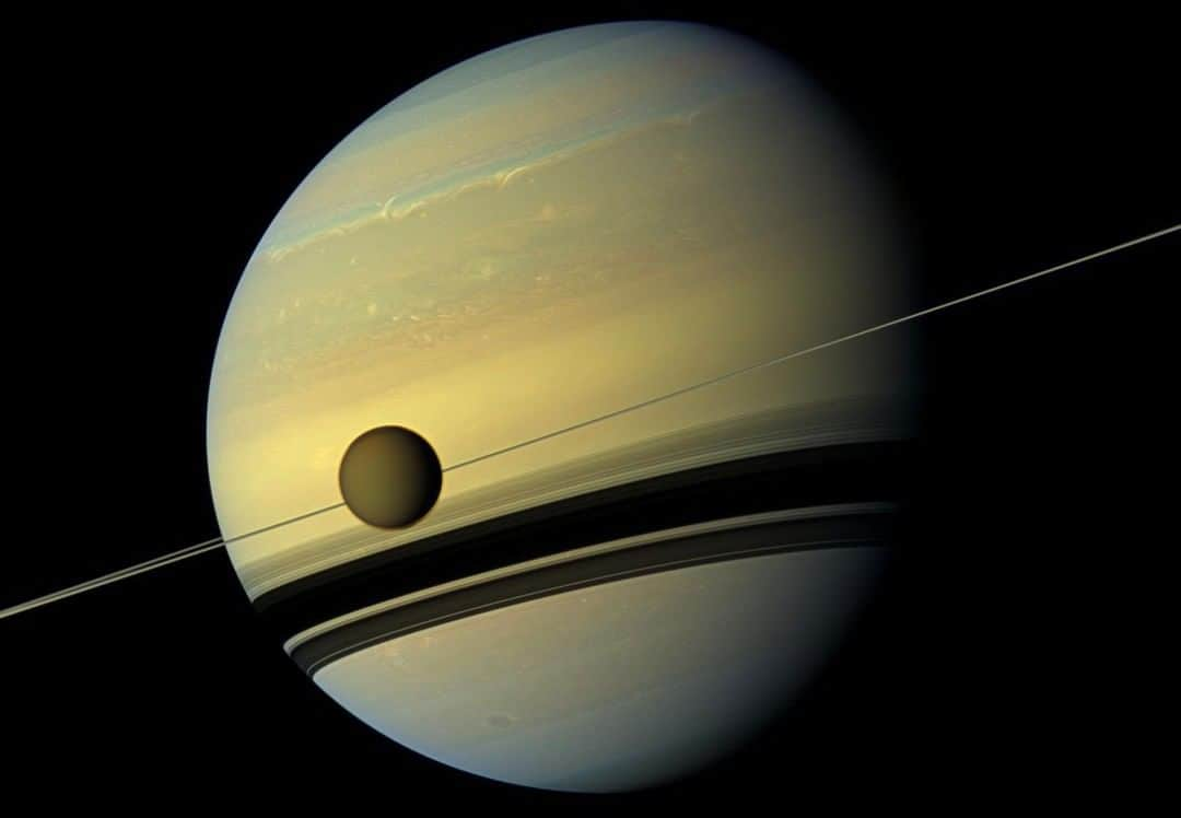 NASAさんのインスタグラム写真 - (NASAInstagram)「Each year, Saturn's moon Titan drifts a little farther away from its planet. ⁣ ⁣ How far does it drift? About 4 inches (11 cm) per year. As a moon orbits, its gravity pulls on the planet, causing a temporary bulge in the planet as it passes.⁣ Over time, the energy created transfers from the planet to the moon, nudging it farther and farther out. ⁣ The discovery was made using data from our @NASASolarSystem Cassini mission to Saturn, which ended in 2017. While scientists know that Saturn formed 4.6 billion years ago in the early days of the solar system, there's more uncertainty about when the planet's rings and its system of more than 80 moons formed. ⁣ ⁣ The revised rate of its drift suggests that the moon started out much closer to Saturn, which would mean the whole system expanded more quickly than previously believed. Click the link in bio for more. ⁣ ⁣ Credit: NASA/JPL-Caltech/Space Science Institute⁣ ⁣ #SolarSystem #Saturn #Titan #Astronomy #NASA #Cassini」6月9日 8時26分 - nasa