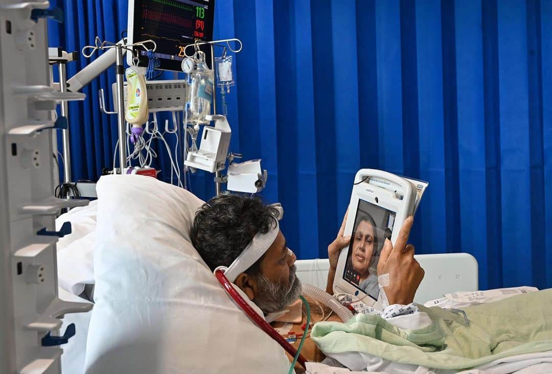 National Geographic Creativeさんのインスタグラム写真 - (National Geographic CreativeInstagram)「Photo by @lynseyaddario | COVID-19 Patient, Foysal Ahmad, 51, speaks with his wife, Nipa Begum, from the Intensive Care unit of the Royal Papworth Hospital in Cambridge, England, June 15, 2020. Foysal was among some of the most severe COVID-19 patients in the country, though after 55 days in the ICU, is making great strides with his recovery. Ahmed is on an ECMO machine, Extracorporeal membrane oxygenation , which essentially does the job of the lungs externally in order to give the body a chance to rest and recover. The Royal Papworth is one of only five centers in England to provide ECMO machines for respiratory failure. Even though the UK's death rate is falling, doctors continue to treat patients for COVID-19 across the country with many fearing a 'second wave' as lockdown rules continue to relax. The official government death toll of COVID-19 in the United Kingdom is one of the highest in the world, with over 41,000 deaths. Featured work shot on assignment for @natgeo. To see more of my work follow @lynseyaddario.」6月17日 16時48分 - natgeointhefield