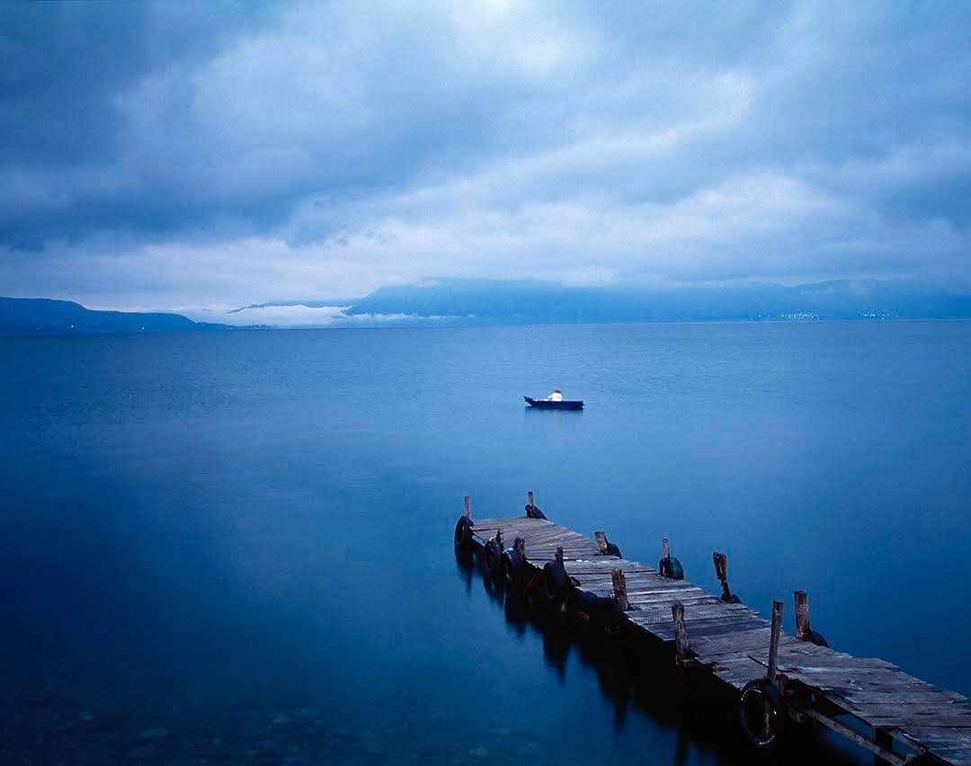 thephotosocietyさんのインスタグラム写真 - (thephotosocietyInstagram)「Photo by @susiepostrust || The morning I took this picture, I woke up well before sunrise to make my way to the banks of Lago de Atitlan, a sparkling blue lake just north of Guatemala's capital, Guatemala City. I wanted to be there before the sun came over the ridge, golden and crisp. To my disappointment at the time, the overcast morning muted the sunrise, which could barely even be seen. I am struck now that it was hard for me to see the beauty that stood before me. I expected something different. I think of this morning now because in February, I had very different expectations for 2020. I didn't anticipate being mostly homebound because of coronavirus or digging deep within myself to understand anew the ways in which I have perpetuated racial injustice in our country. I am confident that there is beauty in this summer of protest and coronavirus. I am hopeful that we won't let this moment pass without making real changes in our country. It is time to challenge the systemic racism that is within our hearts and institutions. Follow me @SusiePostRust for more images and stories.  @thephotosociety @natgeo⁠ ~⁠ ~⁠ ~⁠ #Guatemala | #lagodeatitlan | #lagodeatitlán | #panamericana | #panamericanhighway | #coronavirus | #respondingtothevirus | #LifeIsNotFair | #DoTheWork | #AntiRacism | #lifeontheedge | #Covid-19 | #ShowUp| #WeNeedToChange | ⁠#sunrise | #lakesunrise | #sunrisephotography | #fishing | #durhamnc | #morningsunrise | #duke | #dukeuniversity | #centralamerica | #centralamericatravel | #guatemalatravel | #blacklivesmatter | #antiracism | #fishermen | #fishingboat」6月17日 10時34分 - thephotosociety