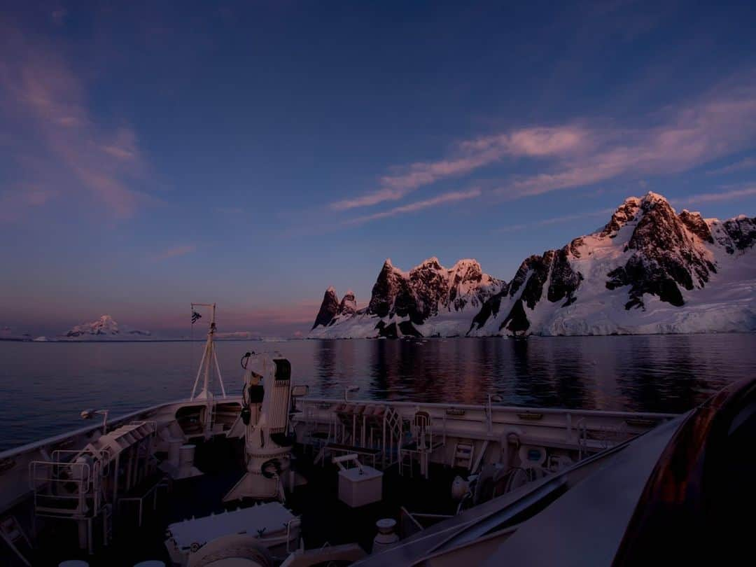 National Geographic Travelさんのインスタグラム写真 - (National Geographic TravelInstagram)「Photo by Michaela Skovranova @mishkusk // Sponsored by @OPPO // A peaceful sunset sailing through the Lemaire Channel is one of the most spectacular sights on the Antarctic Peninsula. Because of the location of the channel, the water is often calm, reflecting the magnificent cliffs that appear to rise out of the water. The channel is 1,600 meters (5,250 feet) wide and runs for 11 kilometers (seven miles), with the passageway only visible once you're almost sailing inside of it. As we sailed into the evening, we watched as the krill drifted up the water column and the humpback whales began to feed all around us. // Uncover the ultimate camera with the OPPO #FindX2Pro and its Ultra Vision Camera System.」6月20日 1時09分 - natgeotravel