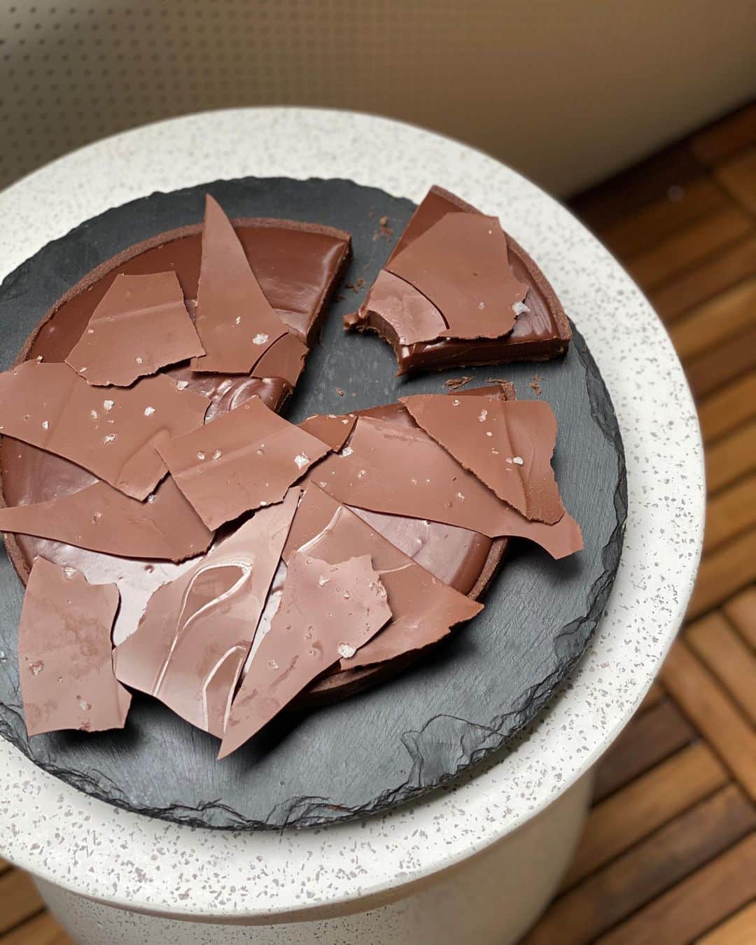 DOMINIQUE ANSEL BAKERYさんのインスタグラム写真 - (DOMINIQUE ANSEL BAKERYInstagram)「Had fun baking on @instagram Live with @phil.rosenthal & @lilyrosenthal to make a Gianduja (Hazelnut Milk Chocolate) Tart to raise funds for @wckitchen. Just in time for (my first!) Father’s Day and my little boy finally home. 😊 Working on getting the full video up but here’s the recipe. Hope you’ll bake it for people you love too. (It’s also in my book #EveryoneCanBake). / FOR GANACHE 1¼ cup heavy cream ¼ cup whole milk 15½ oz (2½ cups) Gianduja* *If you don't have Gianduja, use 11oz dark chocolate & stir in 4.5tsp unsalted butter at the end.  EQUIPMENT Pot Mixing bowl Whisk  1. Combine cream & milk in pot, bring to boil over medium heat. Remove from heat. 2. Place chocolate in bowl. Pour hot cream mixture over chocolate. Let stand 30 sec. Whisk til chocolate is melted & mixture is smooth. / FOR TART SHELL 1½ cups AP flour + more for dusting 2/3 cup powdered sugar 5¼ tbsp cornstarch ¼ tsp salt ½ vanilla bean (or ½ tsp extract) 2½ tbsp unsweetened cocoa powder 10 tbsp unsalted butter, cubed, room temp 1 large egg  EQUIPMENT 8-in tart ring/pan Rolling pin Mixing bowl  1. Combine flour, powdered sugar, cornstarch, salt, vanilla, & cocoa powder in bowl. Add butter, mix w/ your hands (or stand/hand mixer) til butter is size of peas & ingredients combined. Add egg, mix w/ spatula til smooth. Don’t overmix. 2. Transfer dough onto plastic wrap. Shape into a ball. Wrap up & flatten into a disc. Refrigerate 30 min til cold & pliable. 3. Preheat oven to 350F. 4. Flour work surface & rolling pin. Unwrap dough, roll to 1/8 in thick square. Work quickly (add flour if dough sticks). 5. Cut into a round 1 in wider than tart ring. 6. Fonçage dough: Butter tart ring/pan. If using ring, line sheet pan w/ parchment. Set ring in center (no need to do this if using tart pan w/ bottom). Place dough on ring/pan, push down gently w/ your fingers, pressing dough along inside of ring/pan & into edges. Keep even thickness. Trim away excess w/ paring knife (if dough is warm, return to fridge for 15 min). 7. Line shell w/ parchment/coffee filter (fully cover dough). Fill w/ uncooked rice/dried beans. Bake til light golden, 15-20 min. 8. Cool 3 min. Unmold, let fully cool before filling.」6月21日 9時44分 - dominiqueansel