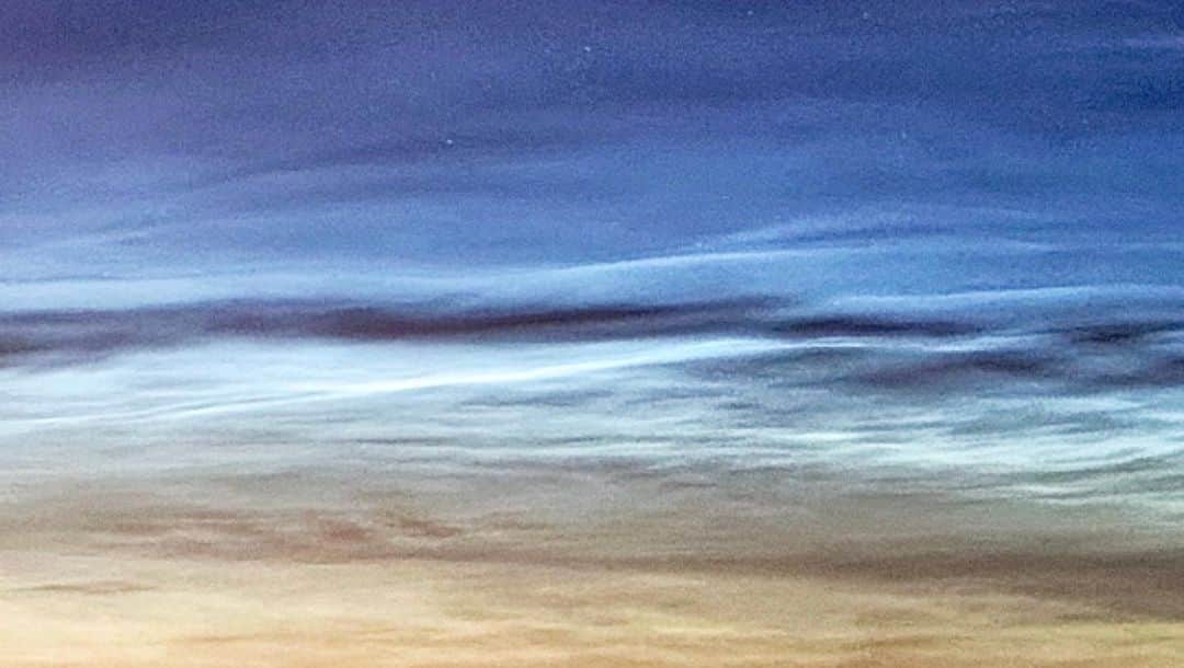 ブライアン・メイさんのインスタグラム写真 - (ブライアン・メイInstagram)「What’s this ? NOCTULUCENT CLOUDS ! This great photo taken last night by astrophotographer Jamie Cooper shows the eery milky light of these clouds - they’re the blue-white streaks in the upper part of the first picture here.  What are they ? Where do they come from? Why do they shine at night ? Well, there is still some discussion about this.  They are generally agreed to be made of ice crystals at an amazing height above the Earth’s surface. Normal clouds drift around, seldom at more than 20,000 feet. These are about 50 miles high ! That’s why sunlight can catch them even though the Sun is way below the horizon to us.  So in Jamie’s picture we see them directly lit by full sunlight, and how different they look from normal clouds, lit only by diffuse reddish light filtered through our atmosphere about an hour and a half after sunset (or before sunrise). LOOK TONIGHT - from your rooftop or the top of a hill - or maybe even from your street corner.  You may catch them.  They only occur at this time of year.  WHY ? Well, that’s the part that in question. The ice crystals need a grain to form around - so it seems they are influenced by the remains of meteors that strike the atmosphere.  But nobody saw these before 1885 - why ? All those shepherds watching their flocks by night ?! They missed them ? Seems unlikely.  And every year recently they seem to be getting more common.  It’s thought that CO2 and Methane assist the process, up there in the Mesosphere, and we know these gases are on the increase due to man’s activities - including emissions from cars and planes - and of cattle farming, for instance.  So this beautiful phenomenon may be a valuable indicator of what Humans are doing to the planet.  Have a look tonight ! You don’t need a telescope - just clear skies - best chance around midnight. 💥💥💥💥 Look towards the North if you are in the Northern hemisphere.  I honestly don’t know what happens in the Southern Hemisphere. Maybe someone will tell me ! Bri @jamiecooperphotography」6月23日 2時48分 - brianmayforreal