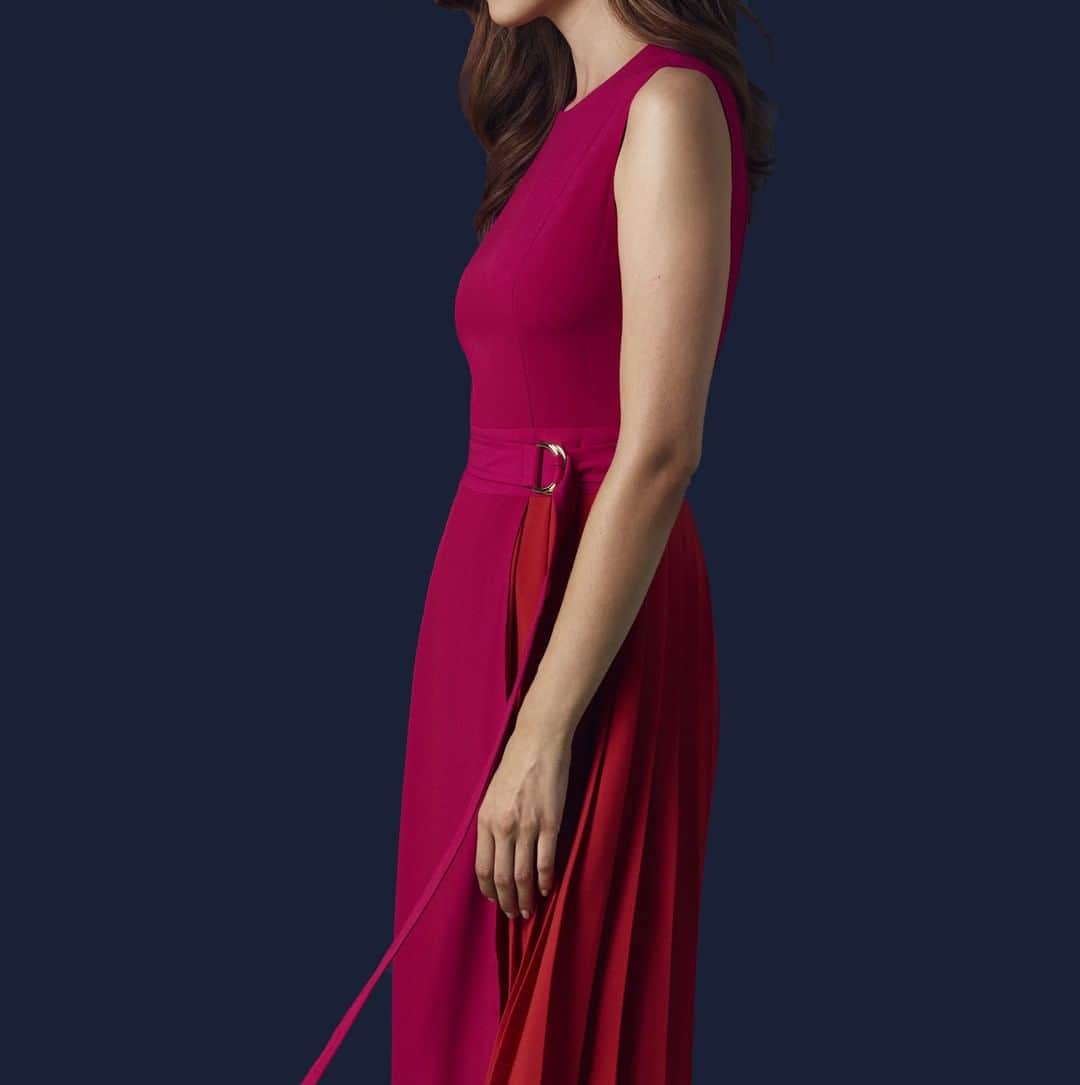 アクアスキュータムのインスタグラム：「This pop-bright #Aquascutum Kalel dress is bound to get you noticed. Made from delicate crepe fabric, this dress will move elegantly when you walk. The all-over fuschia colour is complemented by a shock of paprika in the pleated side panel. An asymmetrical hem adds real visual interest & a d-ring fastening belt completes the look.」