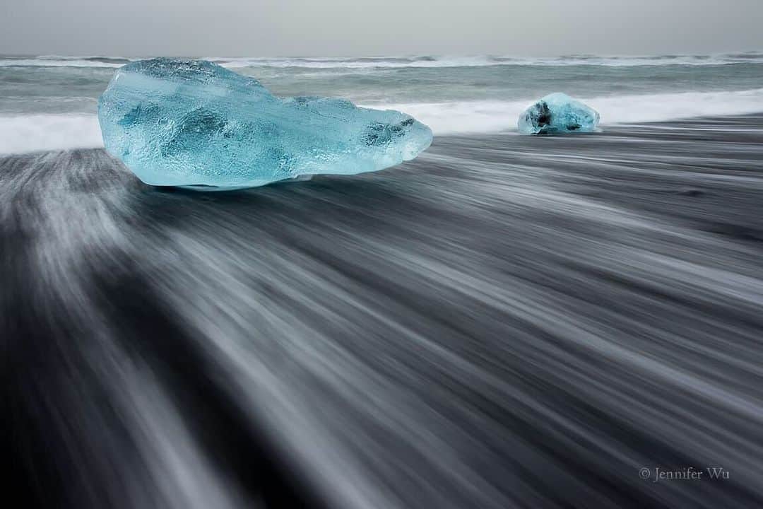 CANON USAさんのインスタグラム写真 - (CANON USAInstagram)「Photo by #CanonExplorerOfLight @jenwuphoto "On a stormy evening with rain and wind at Jökulsárlón in Iceland, I found an iceberg covered beach. The blue icebergs and feathery waves beautifully contrasted with the volcanic black sand beach and dark sky. I waited for a wave to crash on the icebergs and took several shots to be sure to capture it. I set the shutter speed to 1 second to photograph the white wispy waves as they receded back to the surf. I used a polarizer to reduce reflections on the sand and iceberg."  Camera: #Canon EOS-1D X Lens: EF 16-35mm f/2.8L II USM Aperture: f/18 ISO: 100 Shutter Speed: 1 sec Focal Length: 32mm」7月22日 3時59分 - canonusa