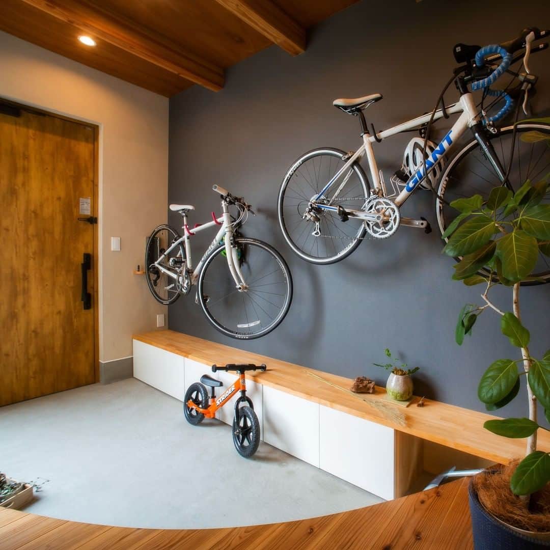 コラボハウス一級建築士事務所さんのインスタグラム写真 - (コラボハウス一級建築士事務所Instagram)「.⠀⠀⠀⠀ 広く取った玄関スペースの壁に、⠀⠀⠀⠀ 趣味のロードバイクを掛けてカッコよく収納。⠀⠀⠀⠀ .⠀⠀⠀⠀ 省スペースかつ実用的なので、ときどき提案してます。⠀⠀⠀⠀ 事前に壁を補強しておけば後付けもできます。⠀⠀⠀⠀ .⠀⠀⠀⠀ 自転車の下には造作で⠀⠀⠀⠀ 腰掛けにもなる靴箱を作りました。⠀⠀⠀⠀ .⠀⠀⠀⠀ 上がり框を曲線にすることで⠀⠀⠀⠀ 靴箱を大きくでき、三和土を広く使えます。⠀⠀⠀⠀ .⠀⠀⠀⠀ こちらのお家は「自転車好きがのびのび暮らす家」として⠀⠀⠀⠀ ホームページの施工例でご紹介しています。⠀⠀⠀⠀ @collabo_house からご覧ください。⠀⠀⠀⠀ ⠀⠀⠀⠀ #玄関 #玄関インテリア #板張り天井 #パイン材 #無垢床 #玄関土間 #土間 #梁 #自転車 #ベンチ #モルタル #観葉植物 #自分らしい暮らし #デザイナーズ住宅 #注文住宅新築 #設計士と直接話せる #設計士とつくる家 #コラボハウス #インテリア #愛媛 #香川 #注文住宅 #ロードバイク #収納 #自転車収納 #曲線 #三和土 #靴箱#造作 #マイホーム」7月22日 20時38分 - collabo_house