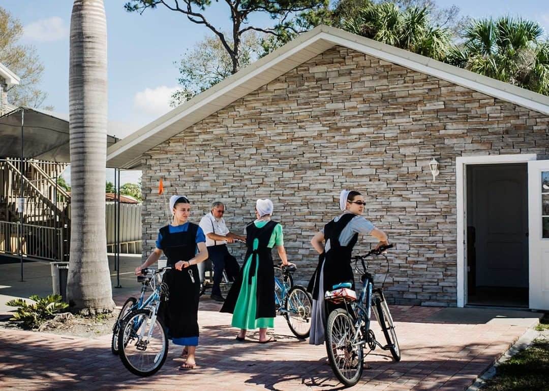 National Geographic Travelさんのインスタグラム写真 - (National Geographic TravelInstagram)「Photo by @dina_litovsky  Young Amish women pick up their bicycles in Pinecraft, Florida. For many decades, Amish and Mennonite families from around the United States have been taking winter vacations in Pinecraft, a small neighborhood in Sarasota. The strict rules of Anabaptist life are temporarily relaxed as hard work is replaced by leisure and recreational activities. For more images, follow me @dina_litovsky.」7月22日 21時07分 - natgeotravel